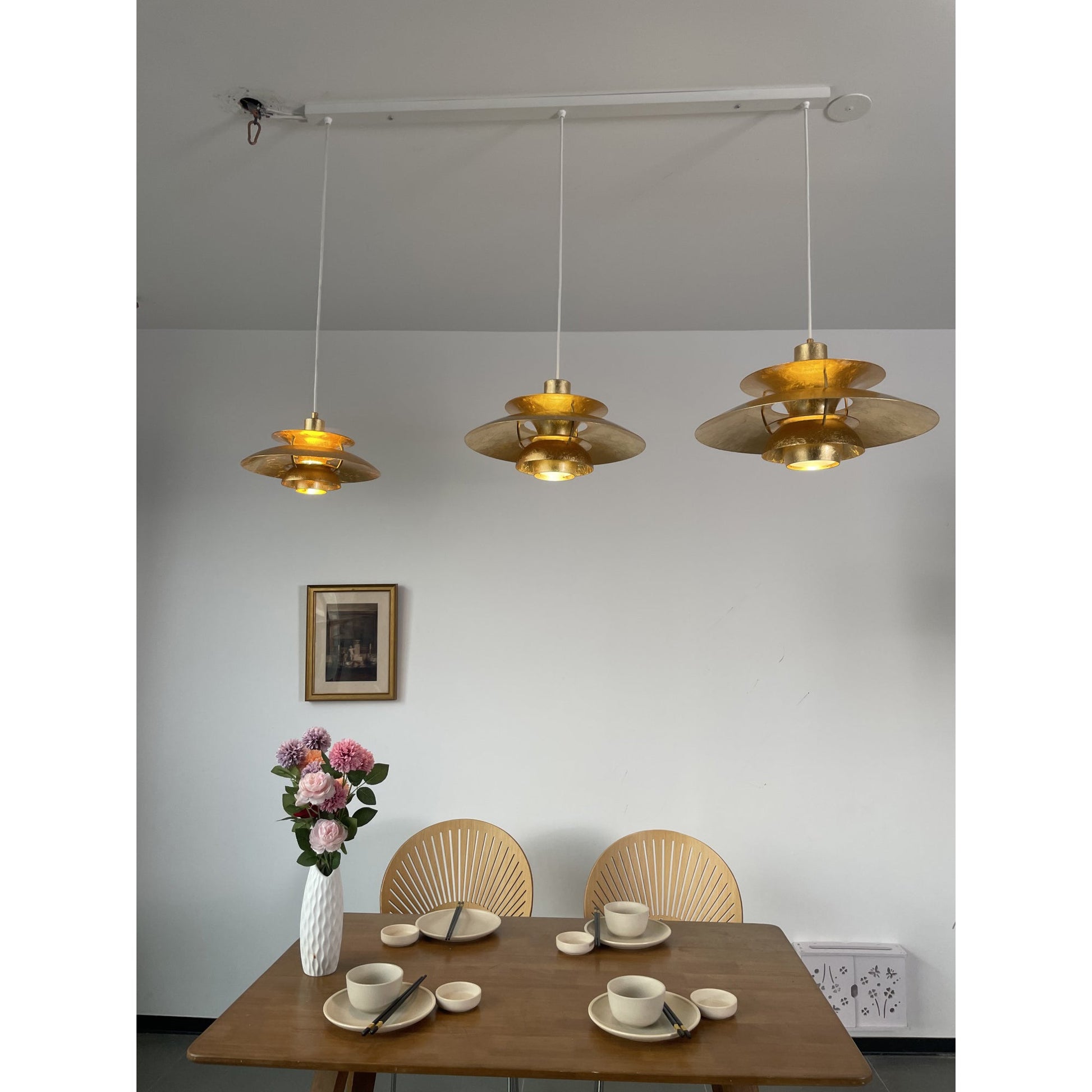 Gold foil lamp casting patterns on a nearby wall.