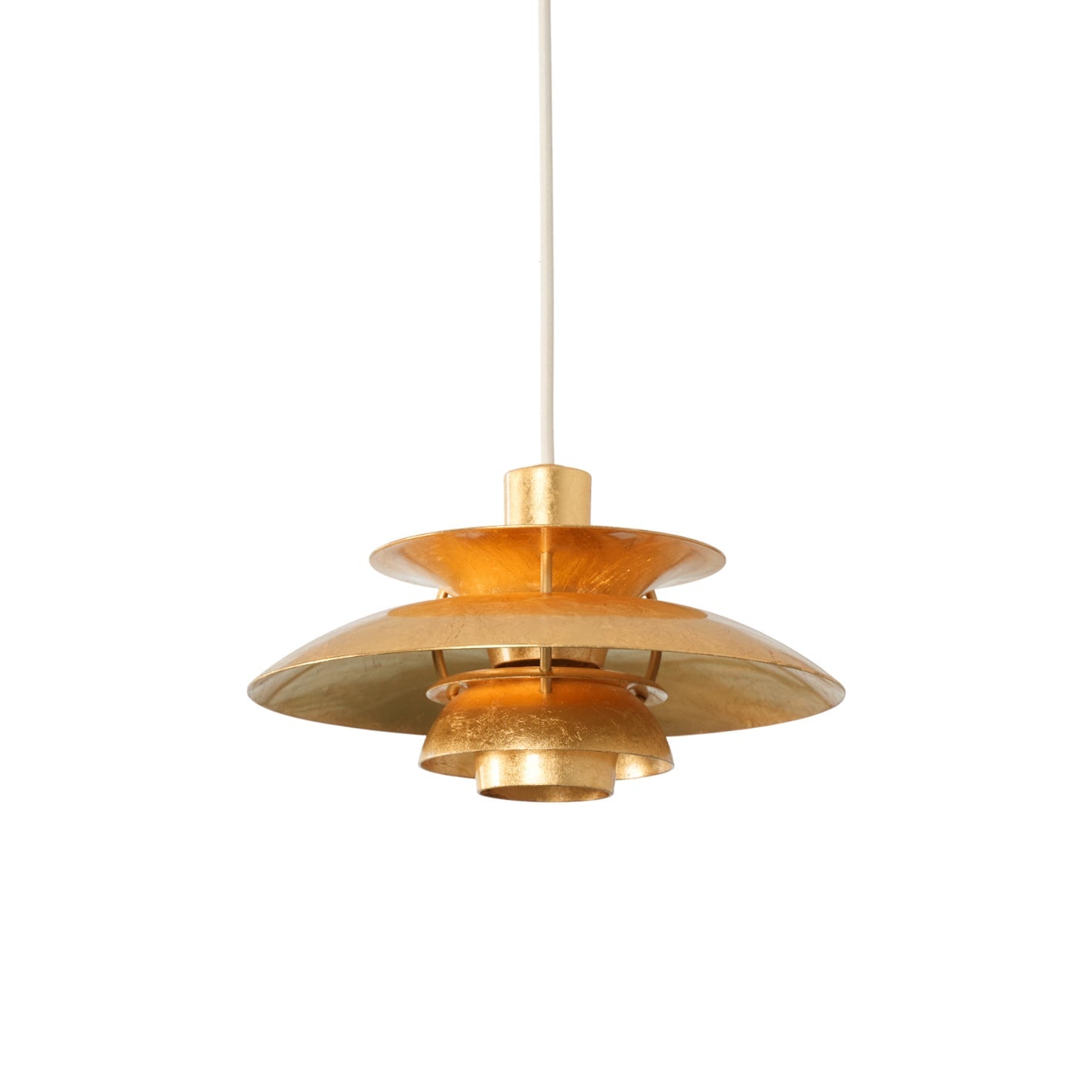 Gold Foil PH Pendant Lamp hanging in a modern living room.