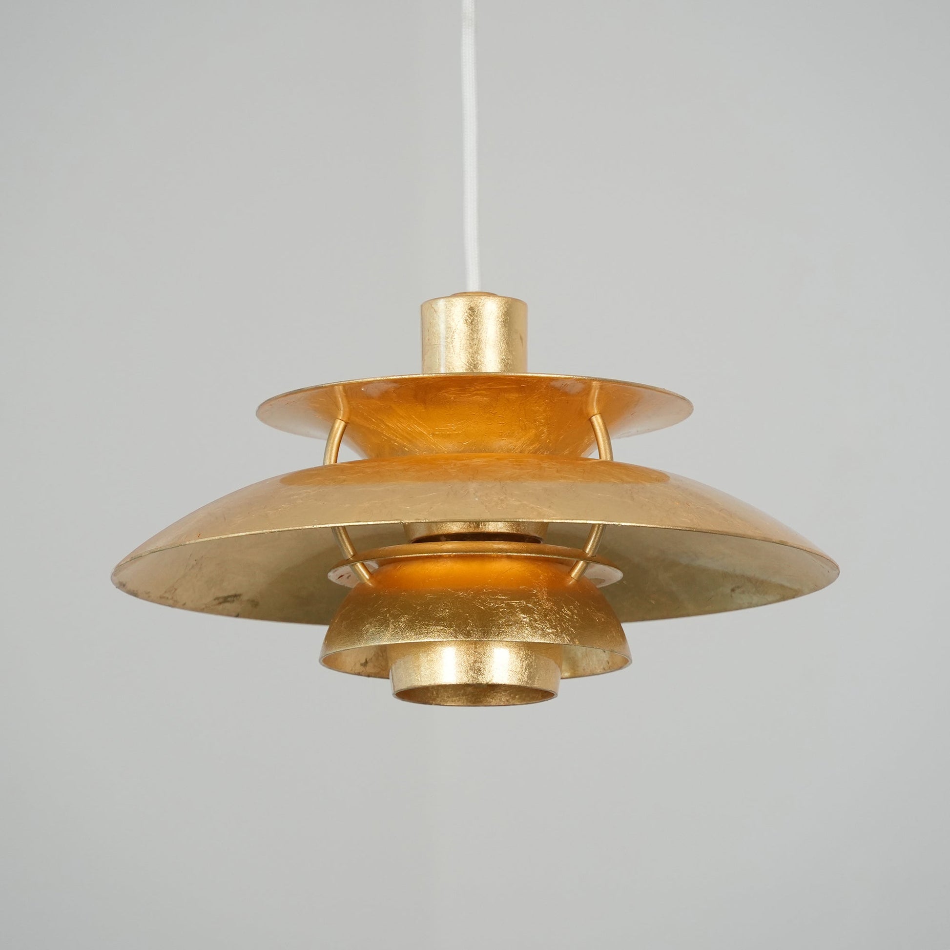The silver foil version of the pendant lamp in a bright kitchen.