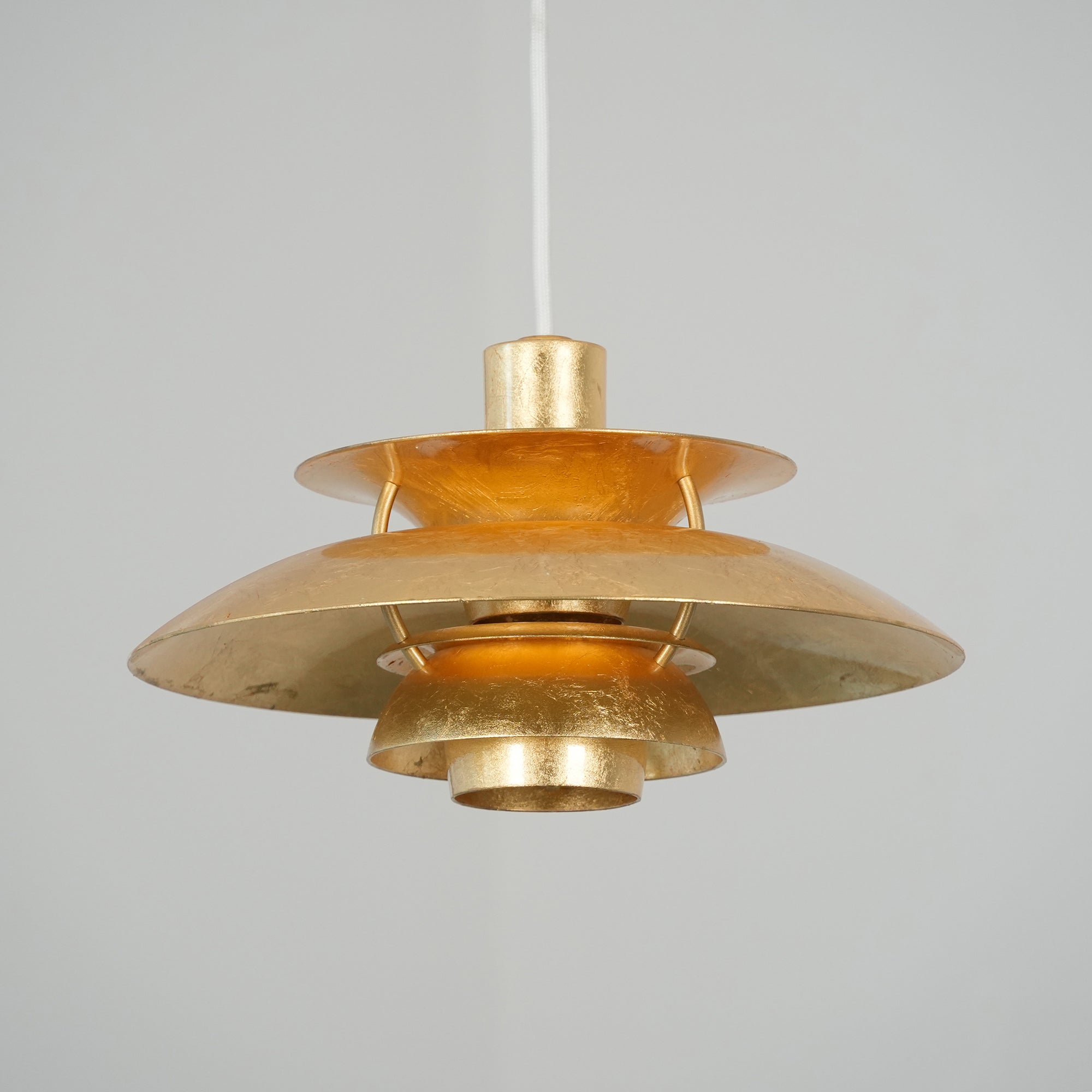 The silver foil version of the pendant lamp in a bright kitchen.