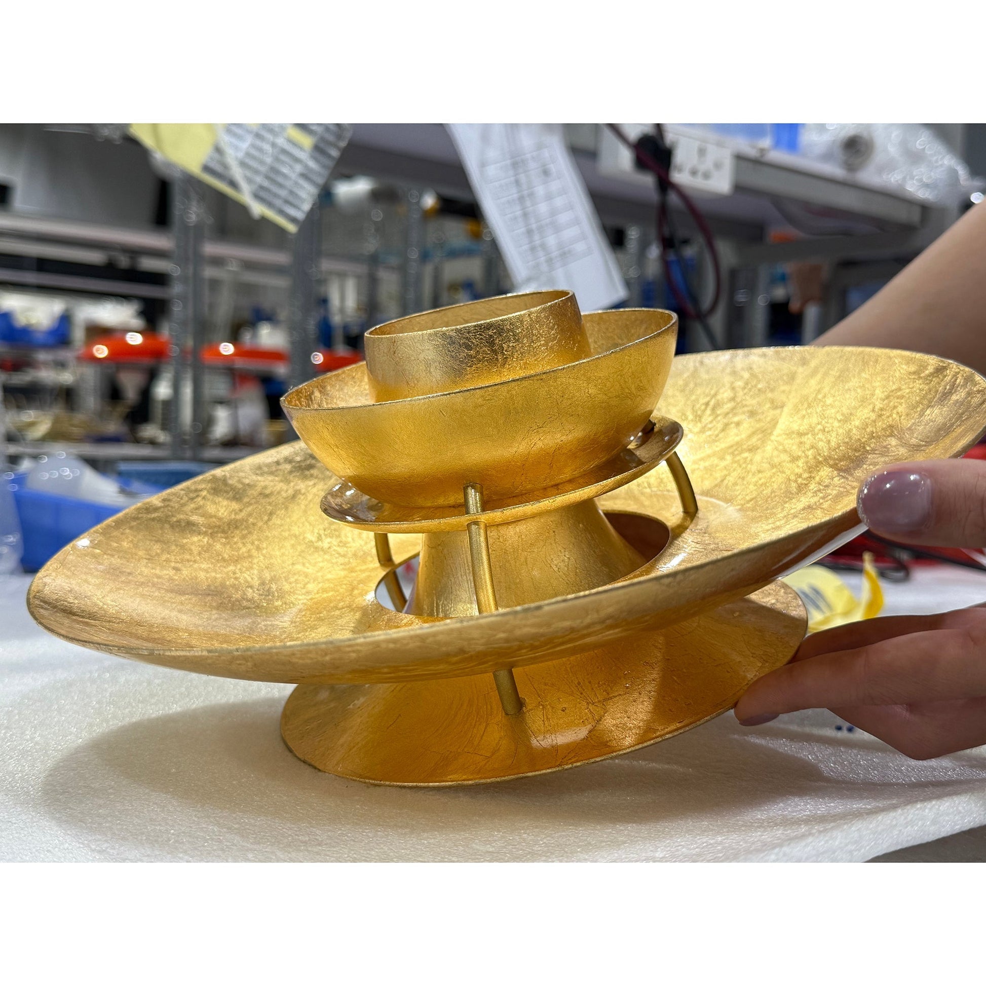 The gold foil lamp hanging in an entryway.