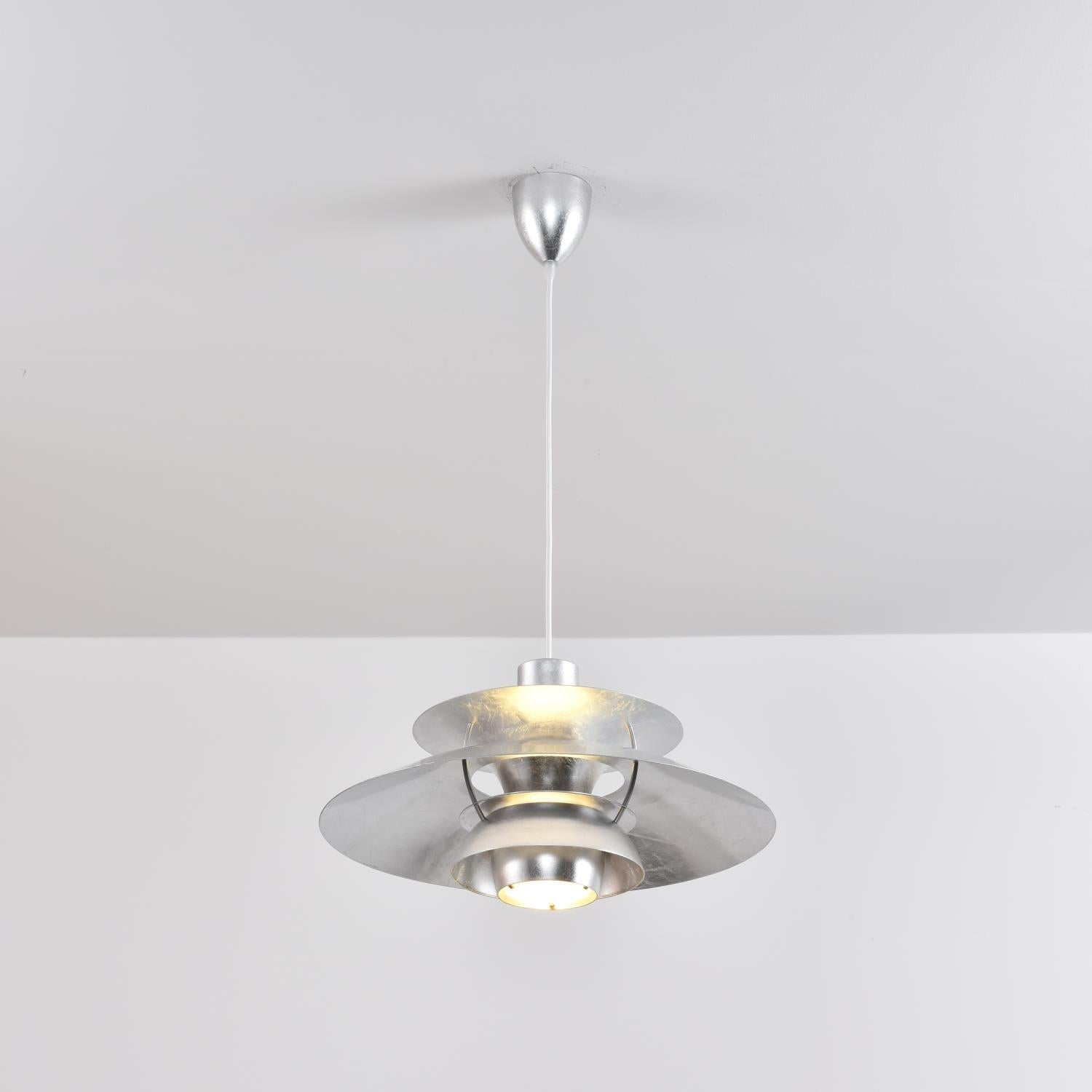Gold Foil PH Pendant Lamp in a dark, moody interior.