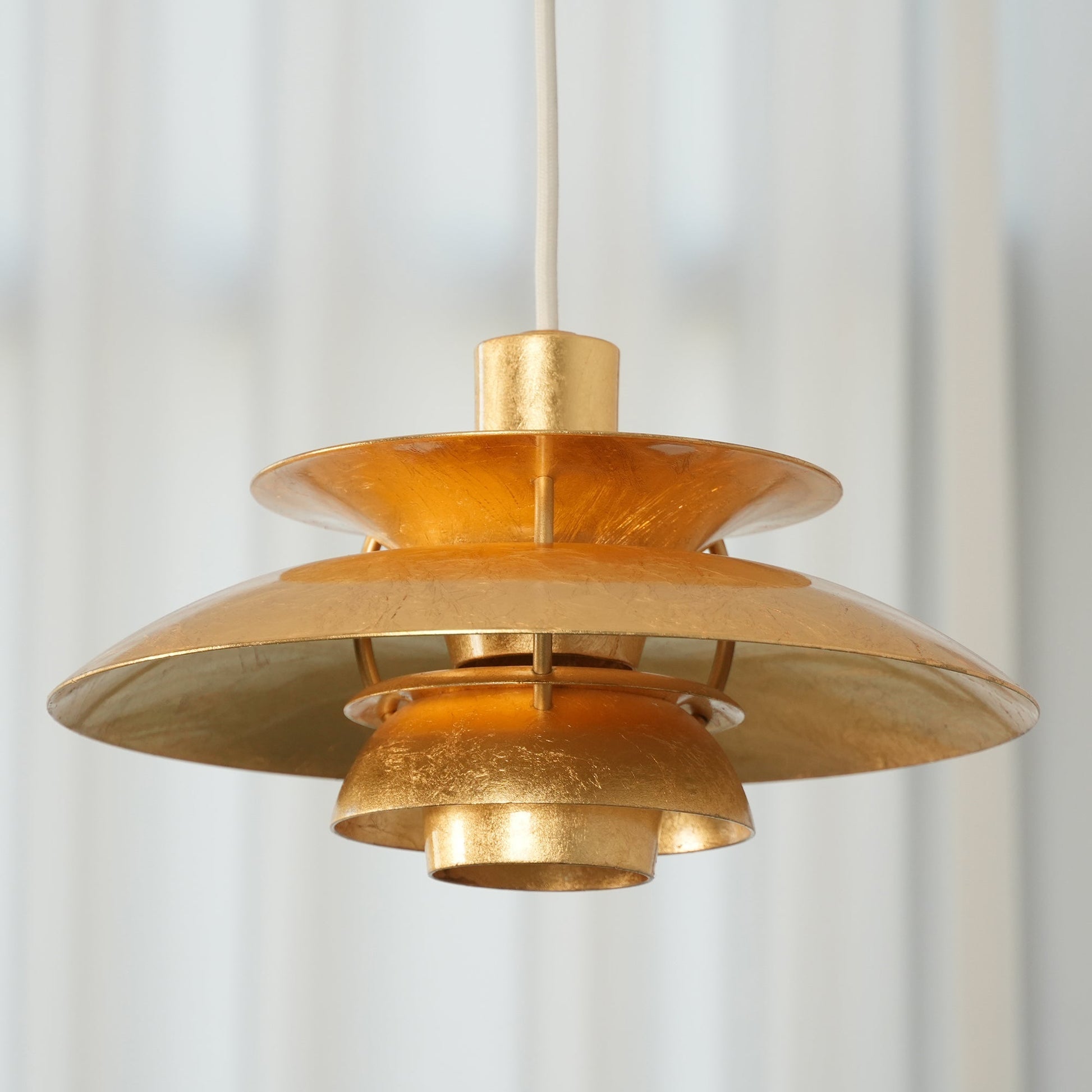 Detail shot of the gold foil texture on the lamp's shades.