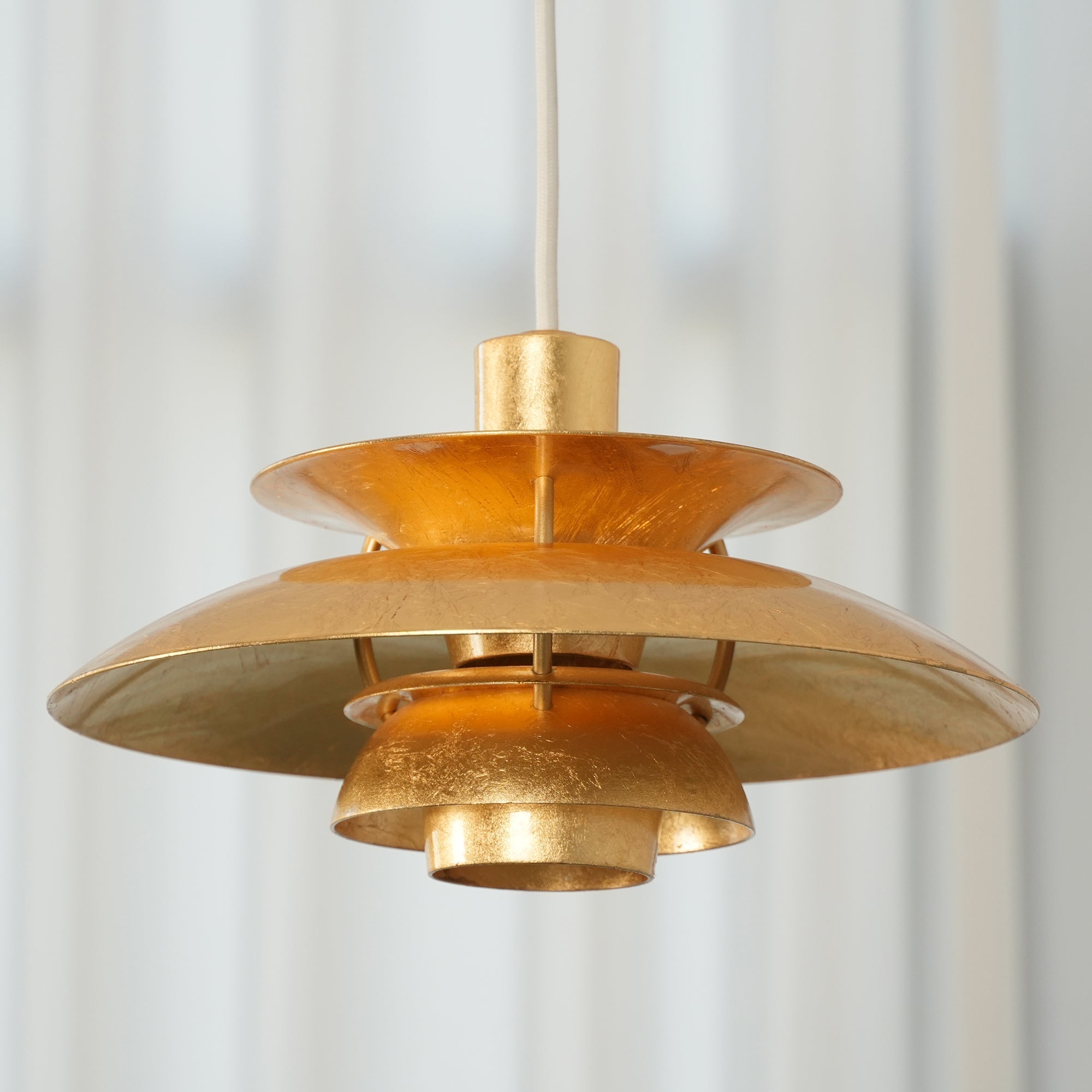 Detail shot of the gold foil texture on the lamp's shades.