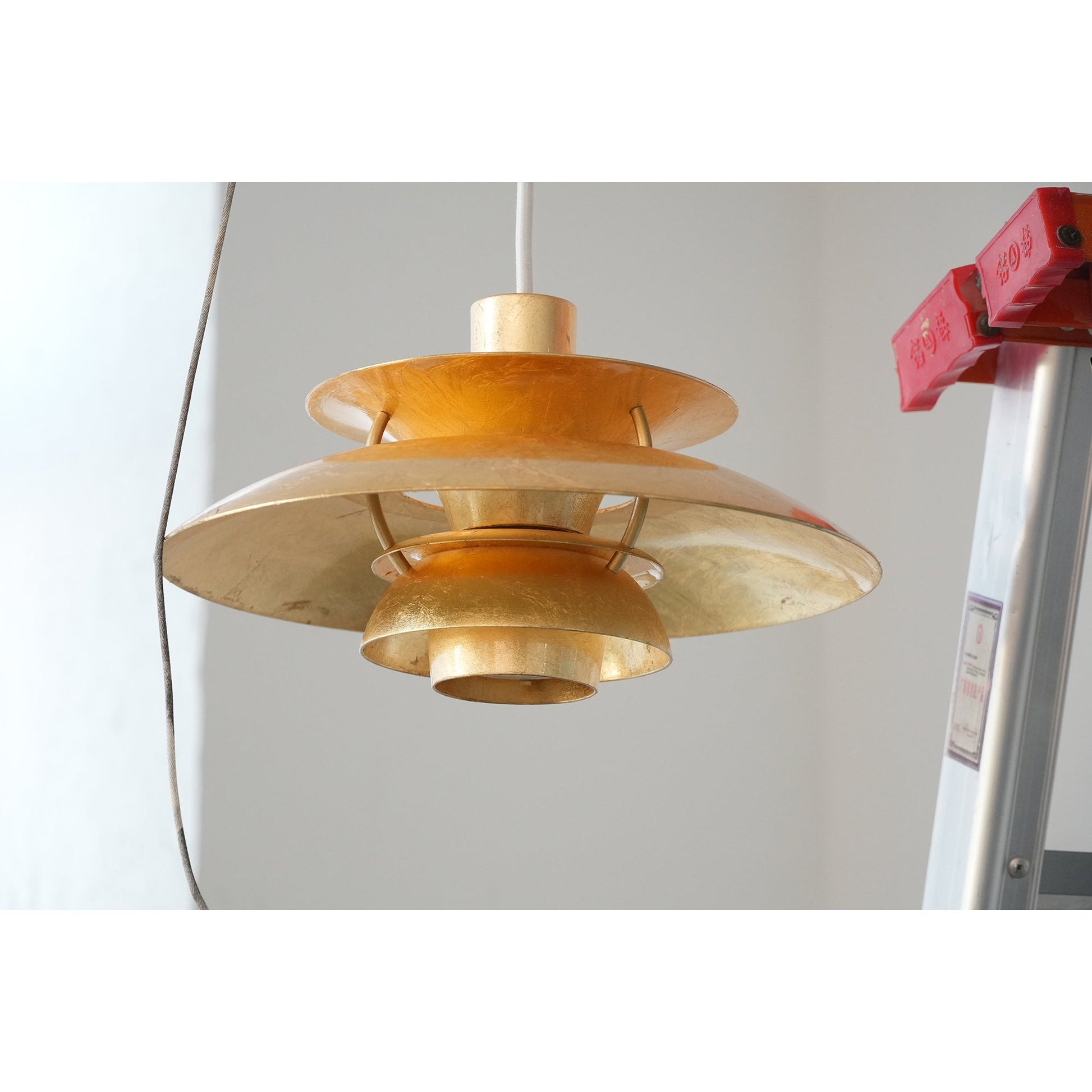 The layered shades of the silver foil pendant lamp.