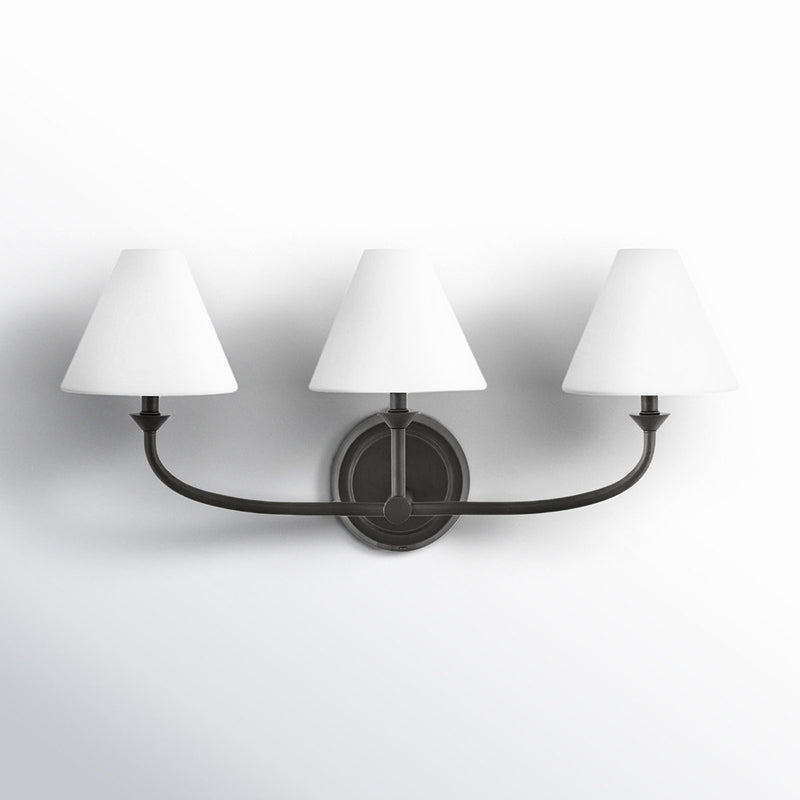 Greta Wall Lamp in a contemporary bathroom above a vanity.