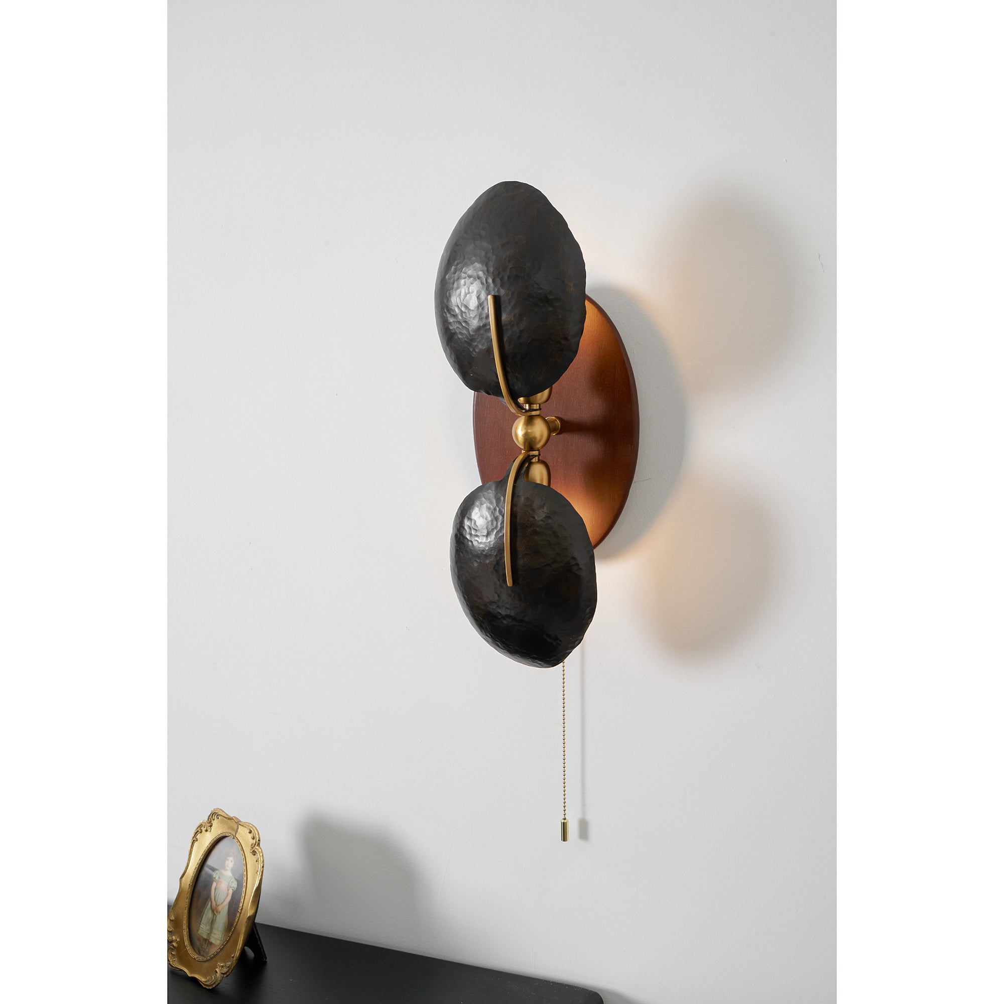Comparison of the black and gold shade options for the Greta Wall Lamp.