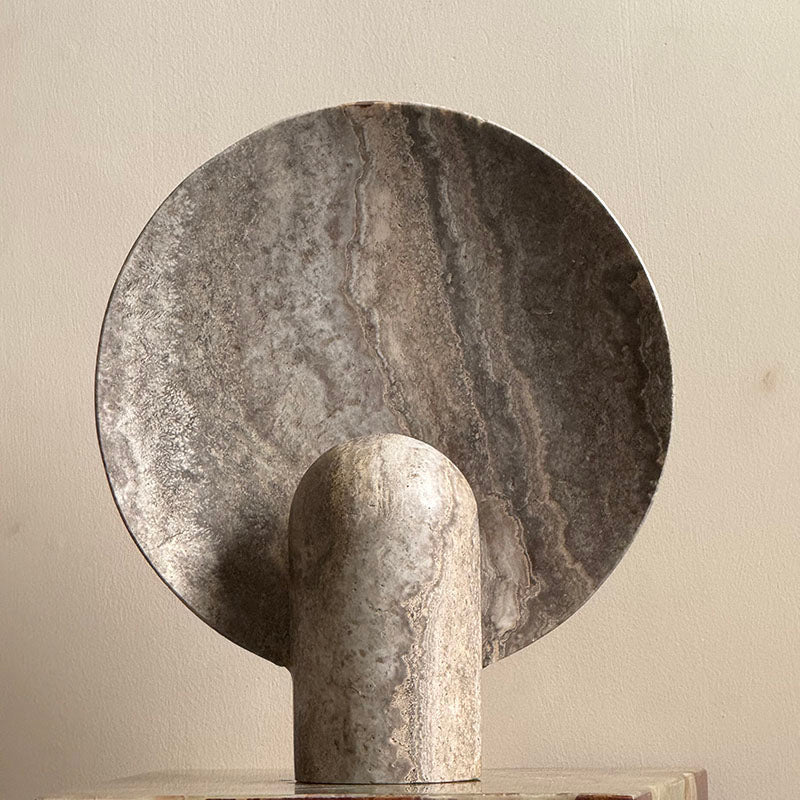 Beige travertine lamp showing its porous texture.