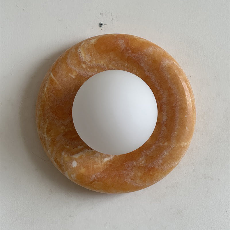 The Orli Sconce illuminated, casting a soft, warm glow.