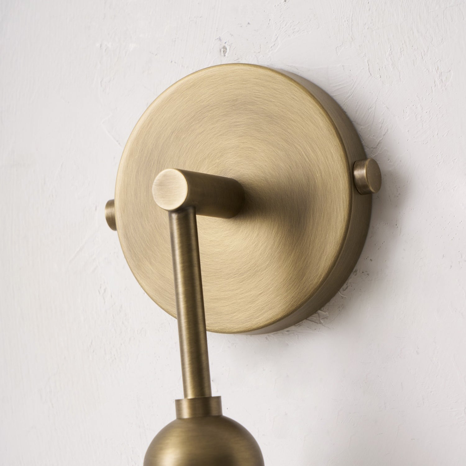 Close-up on the G9 bulb base of the Metro Wall Lamp.