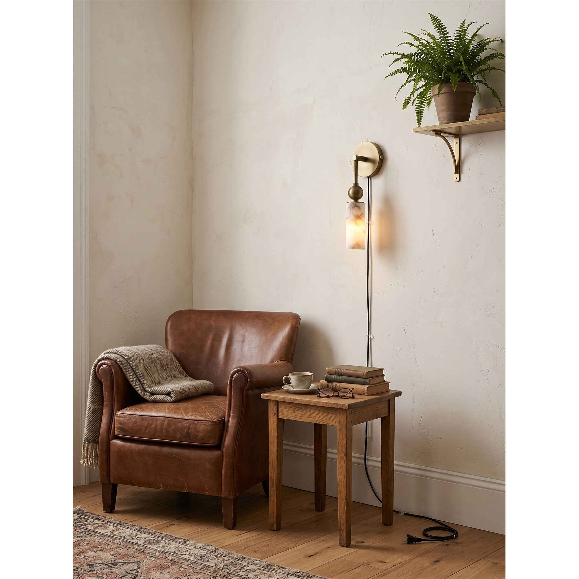 Harlin sconce mounted above a console table in a minimalist entryway.