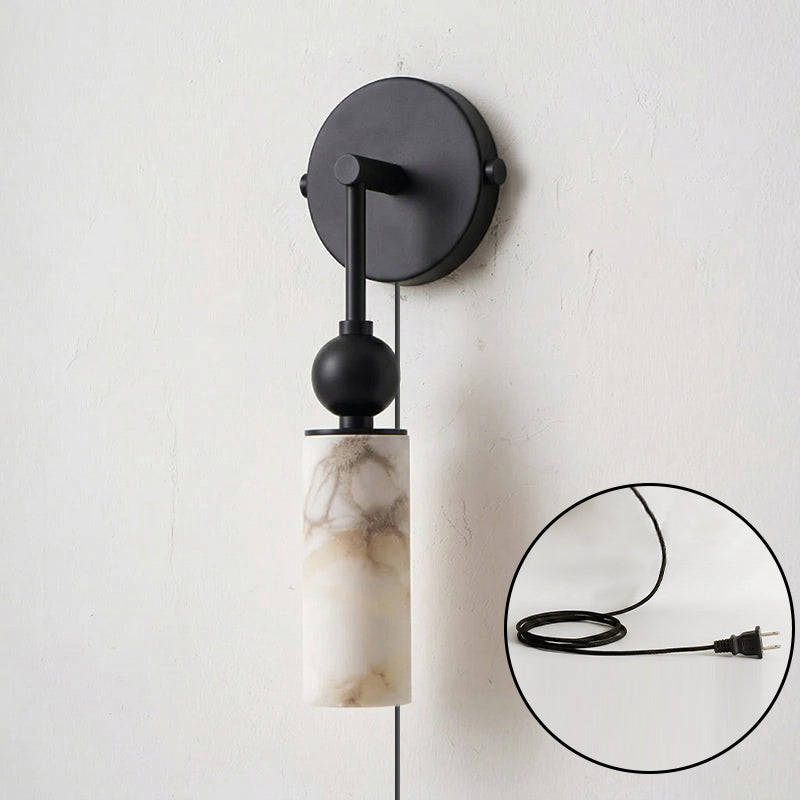 Harlin sconce shown against a dark wall for a dramatic contrast.