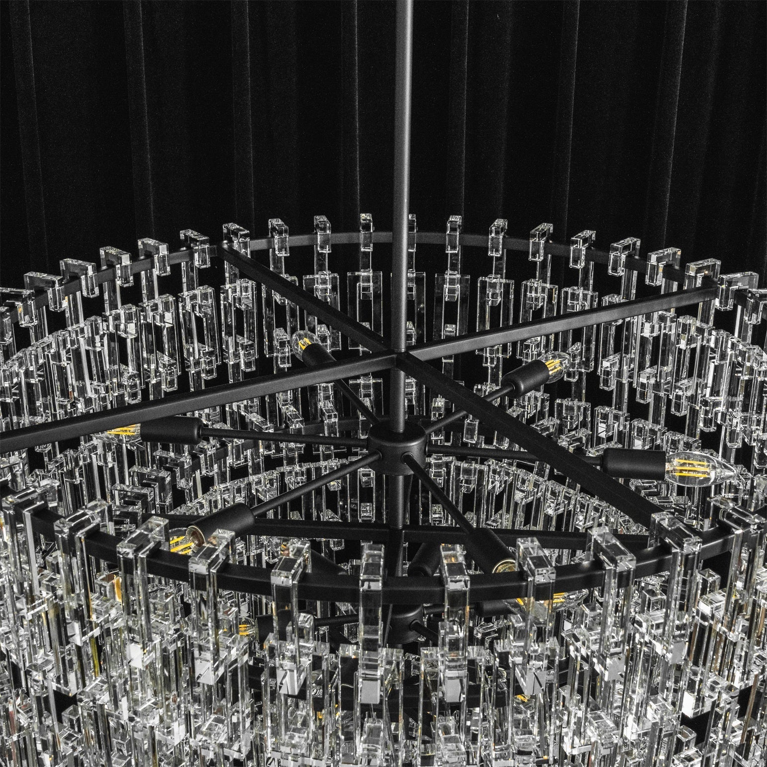 Lifestyle image of the chandelier in an open-concept living space.