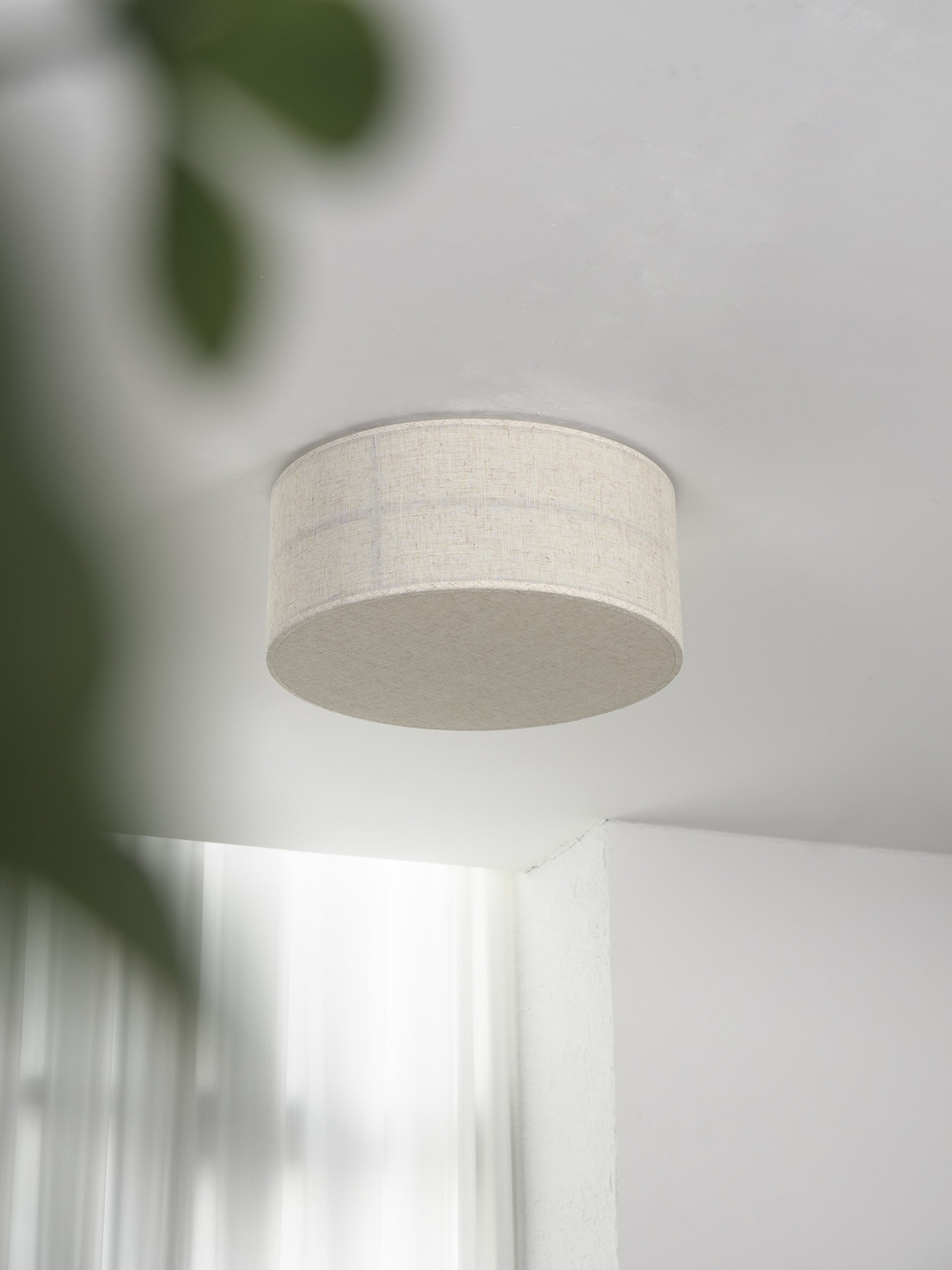 The lamp's minimalist form against a white ceiling.