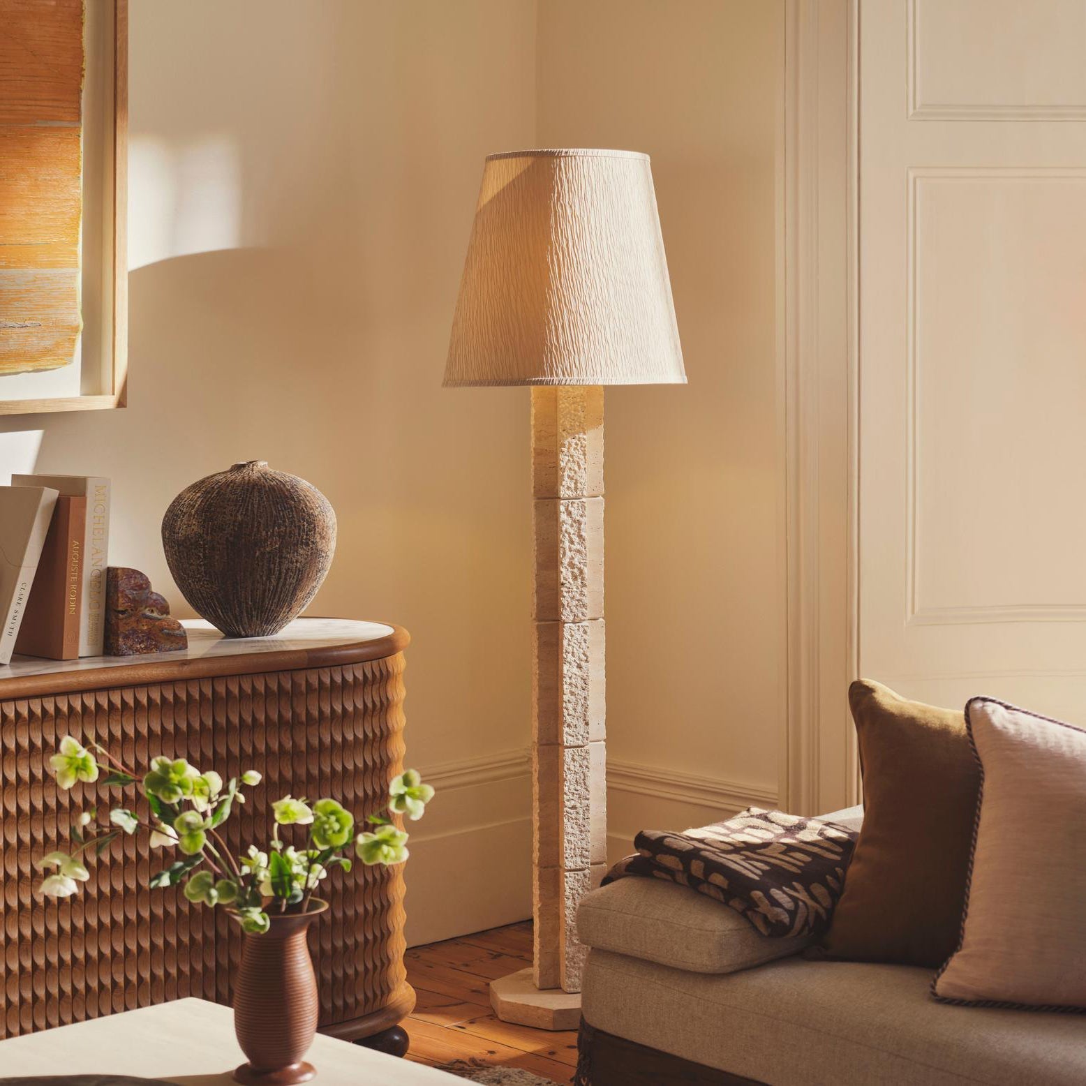 Close-up of the Hawksworth Floor Lamp's textured octagonal travertine stem.