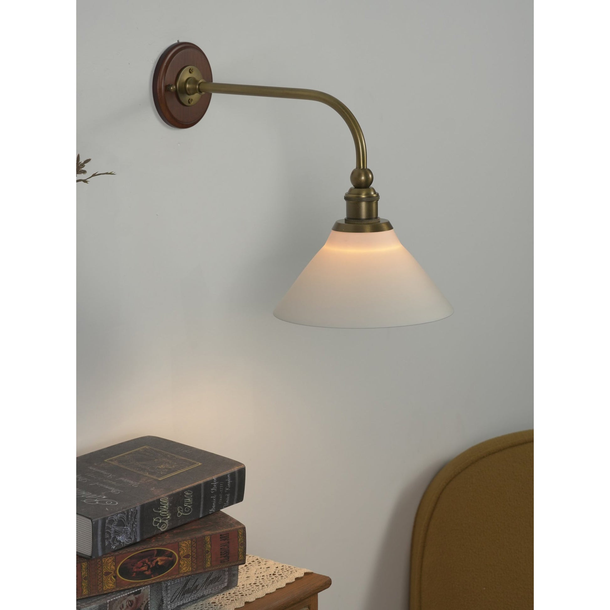 Lifestyle image of the wall lamp in a cozy corner.