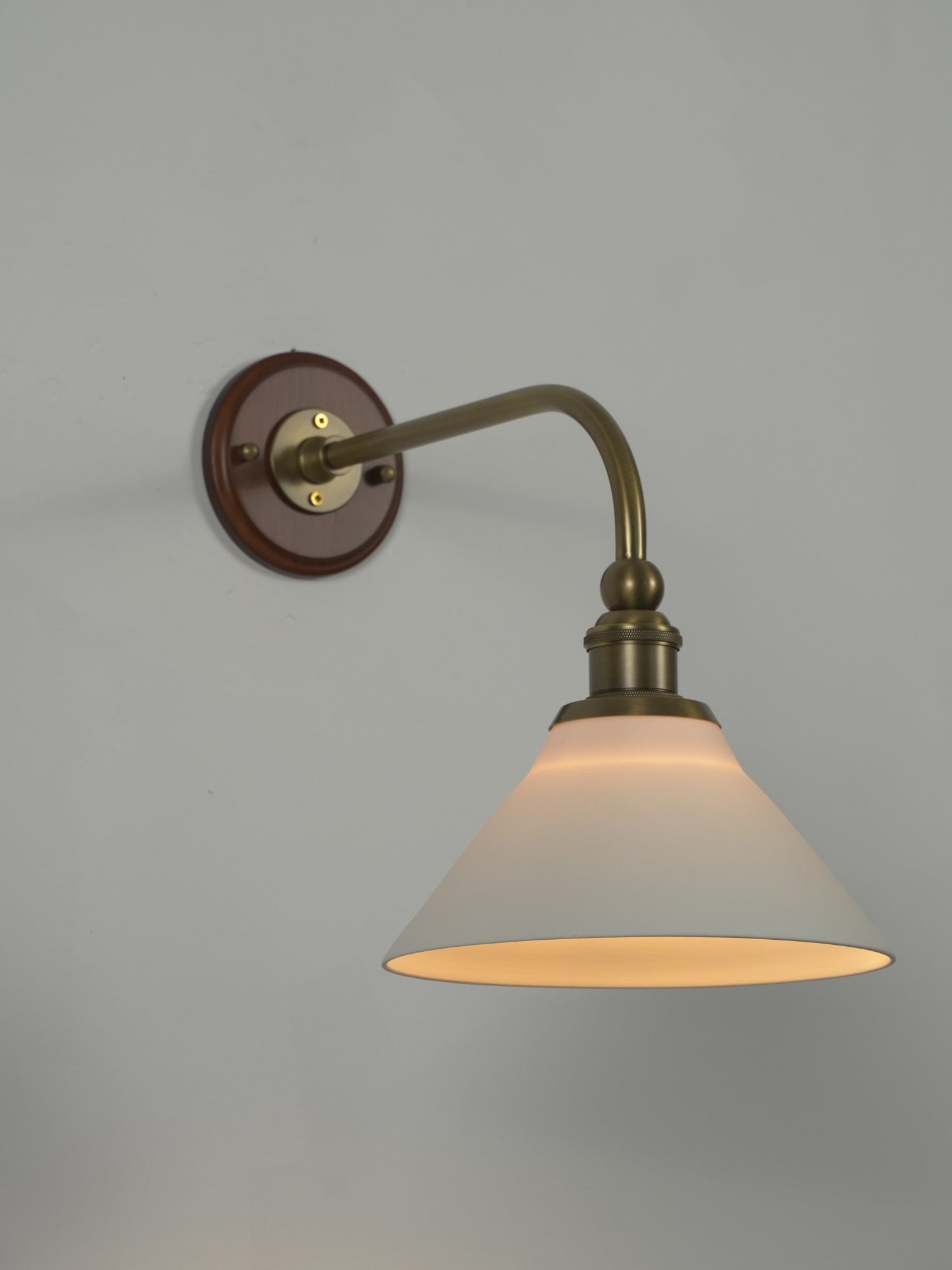 Heirloom wall lamp in a bedroom setting.