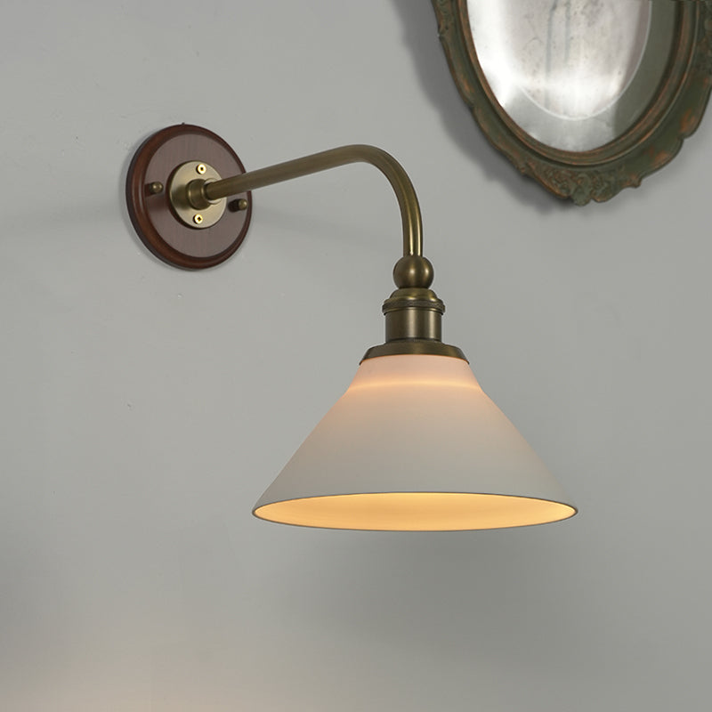 Angled view of the Heirloom ceramic wall lamp against a plain wall.