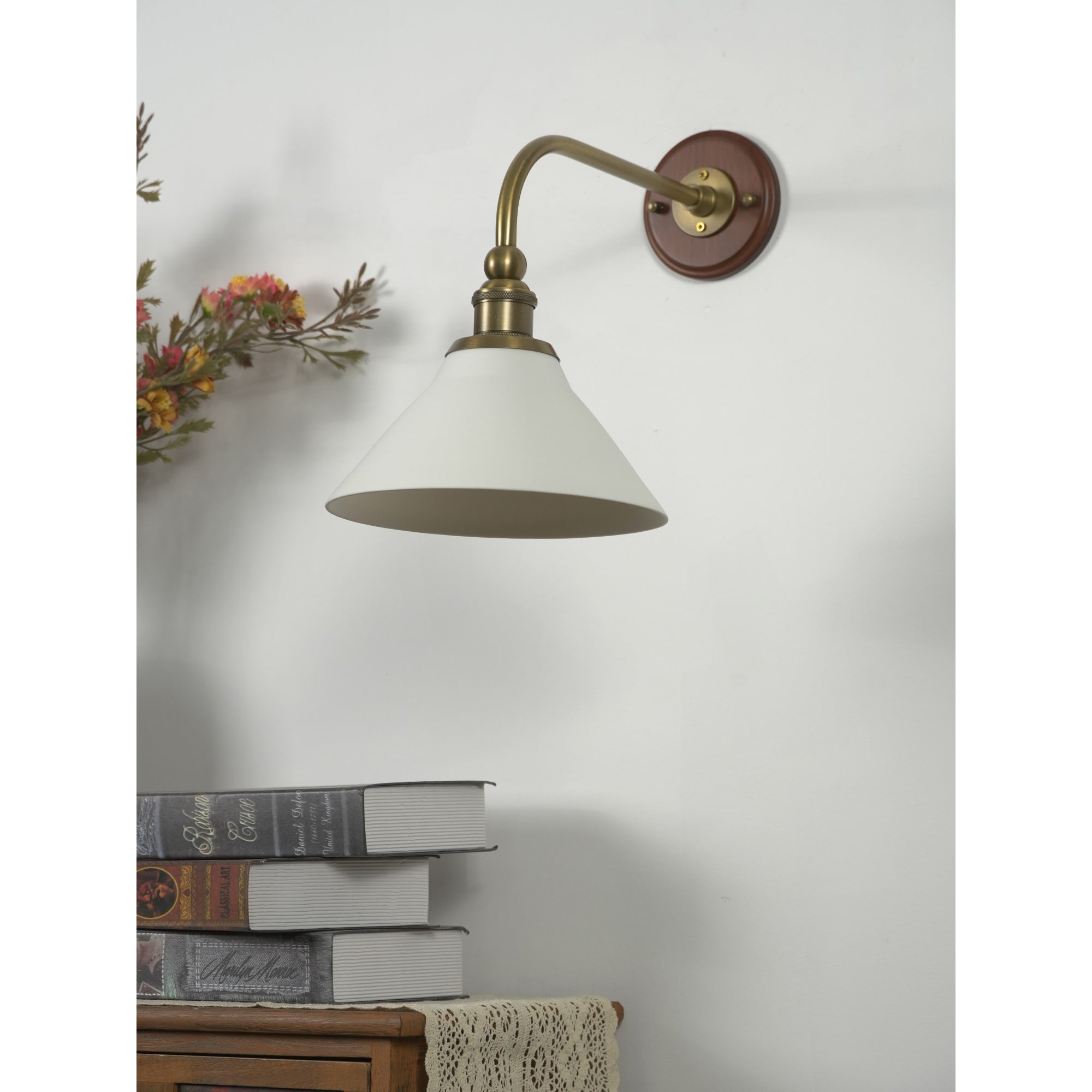 The wall lamp casting a warm, inviting glow.