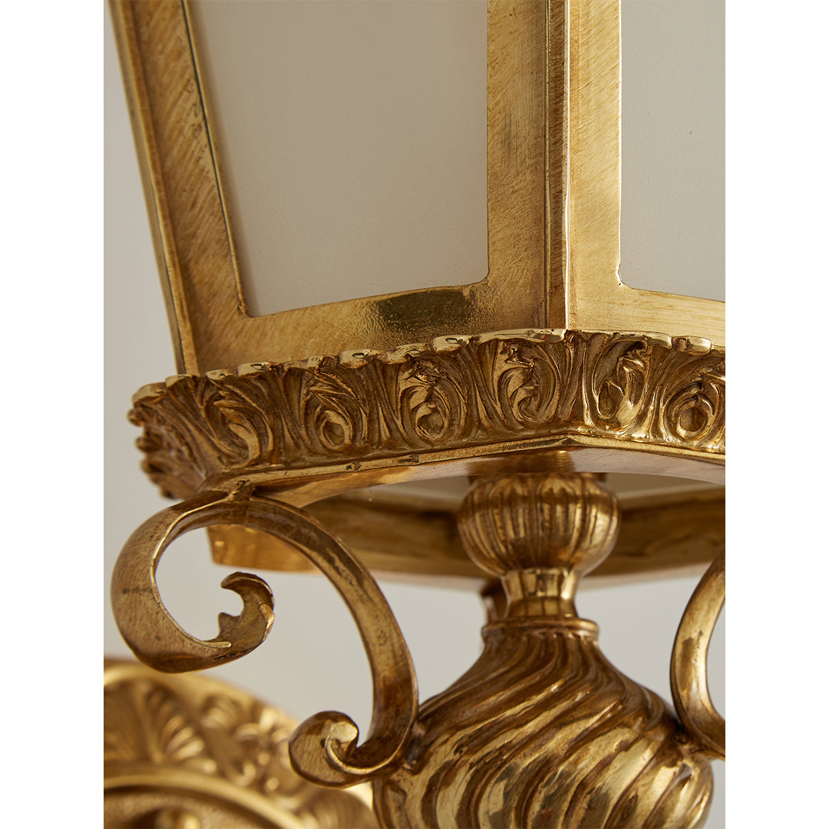 Close-up on the connection between the brass body and glass shade.