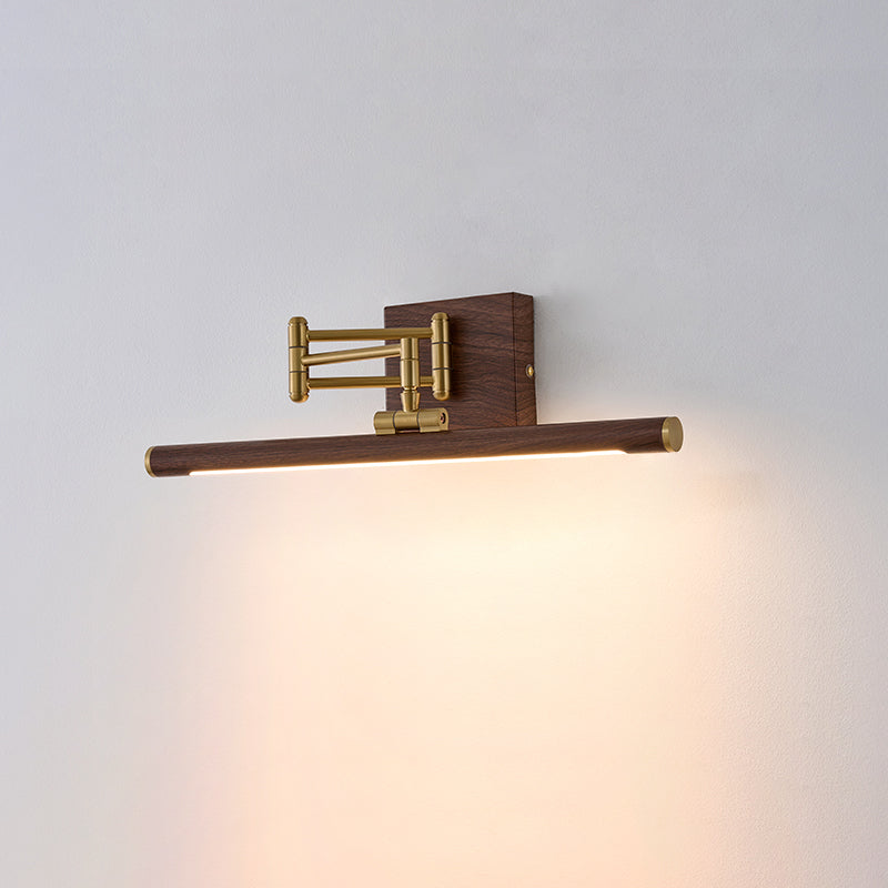 The brass wall lamp shown with light directed to the left.