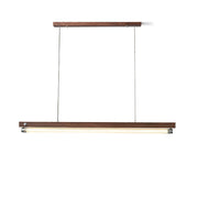 Hiromi Linear Chandelier in walnut finish hanging over a modern dining table.