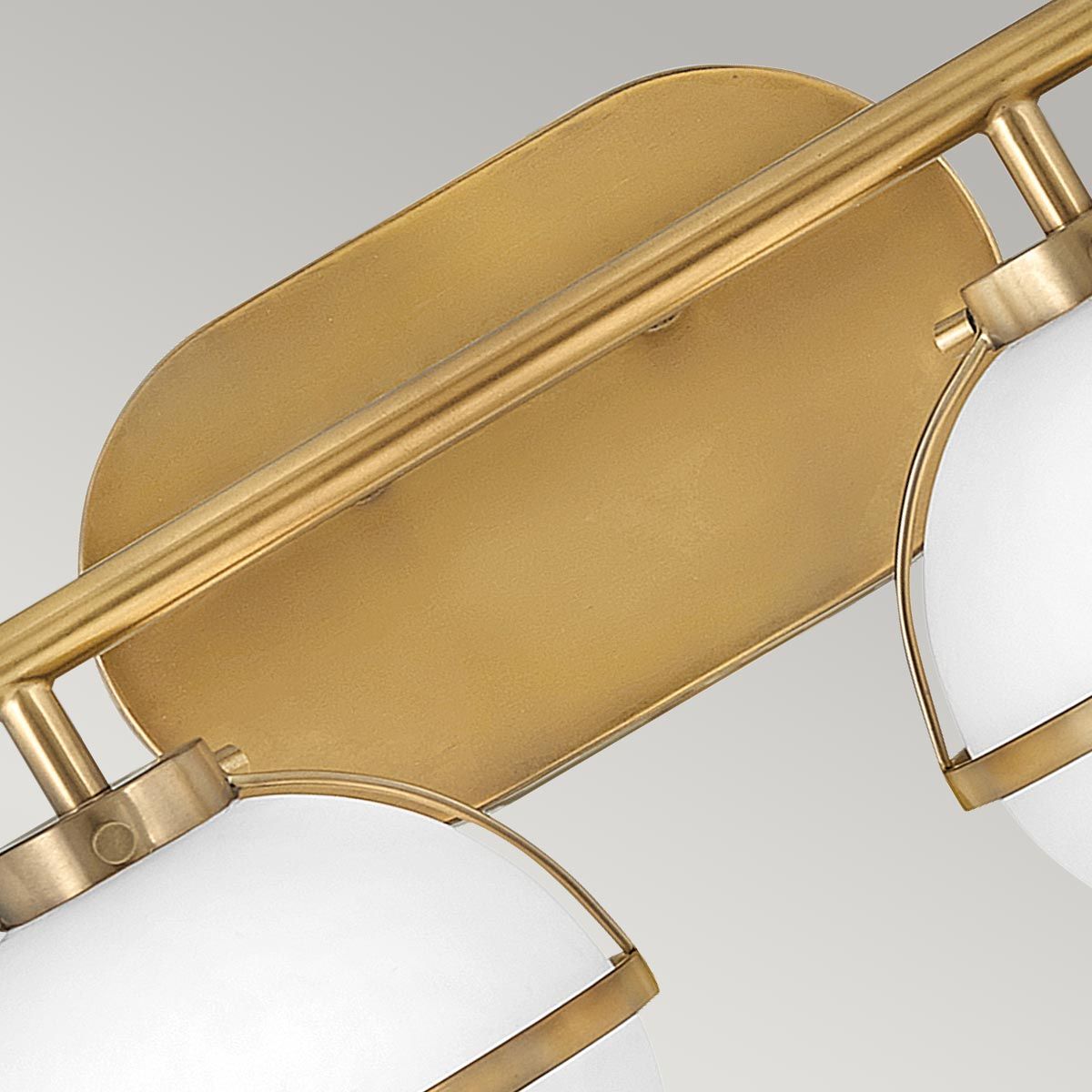 Hollis Wall Lamp with two heads in brass finish and white glass shades.