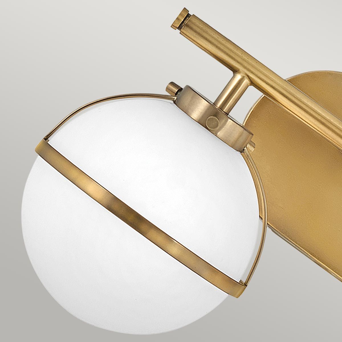 Hollis Wall Lamp with three heads in brass finish and white glass shades.