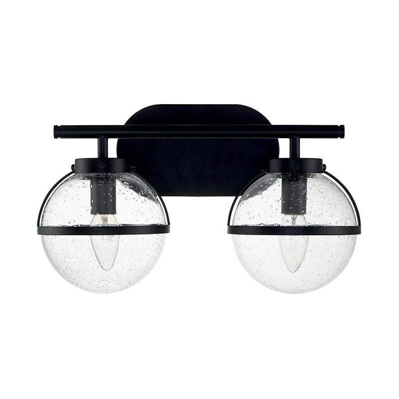 Three-head Hollis Wall Lamp in black against a light wall.
