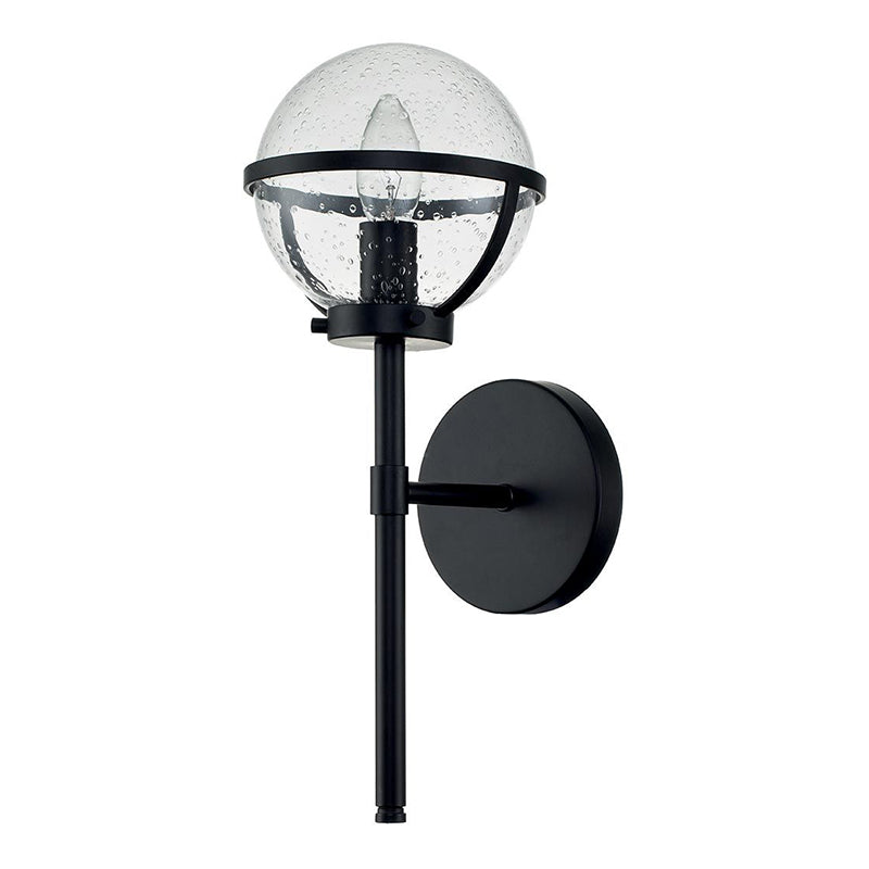 The Hollis Wall Sconce adding a touch of elegance to a bedroom.