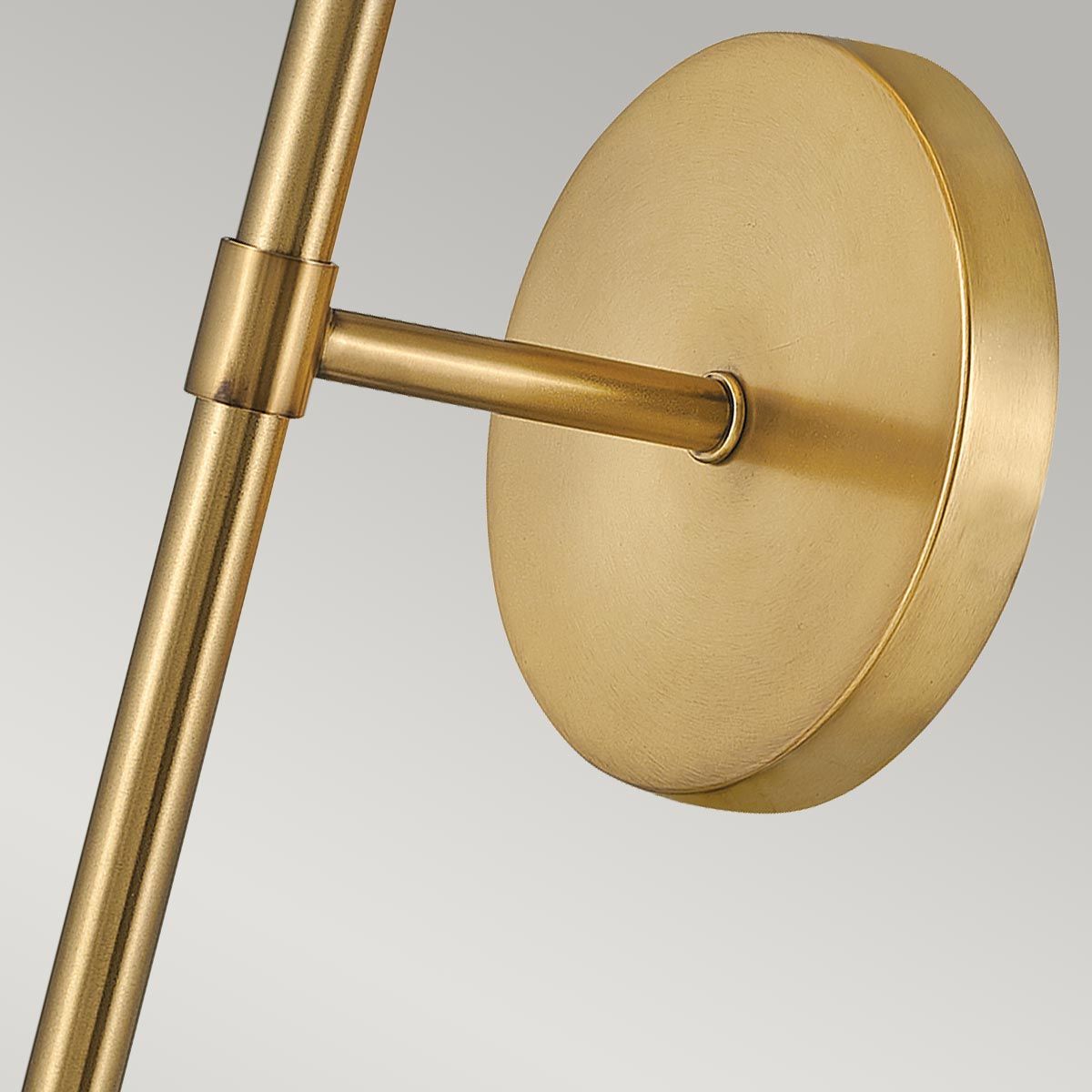 The Hollis Wall Sconce illuminated, casting a warm and inviting glow.