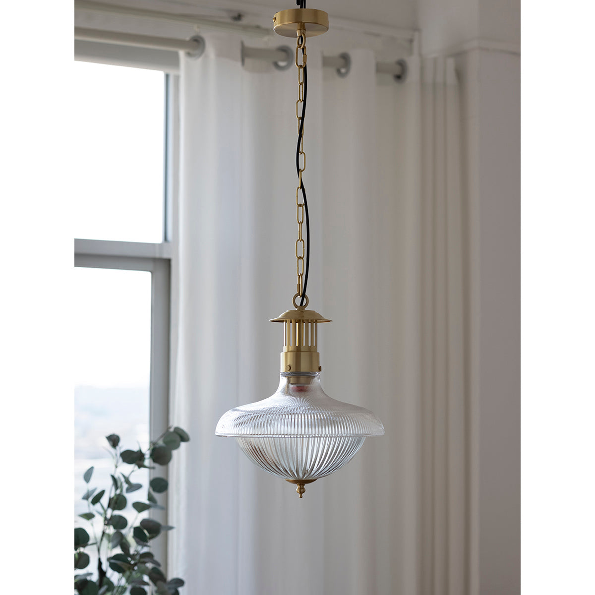 The clear glass shade against a neutral background.