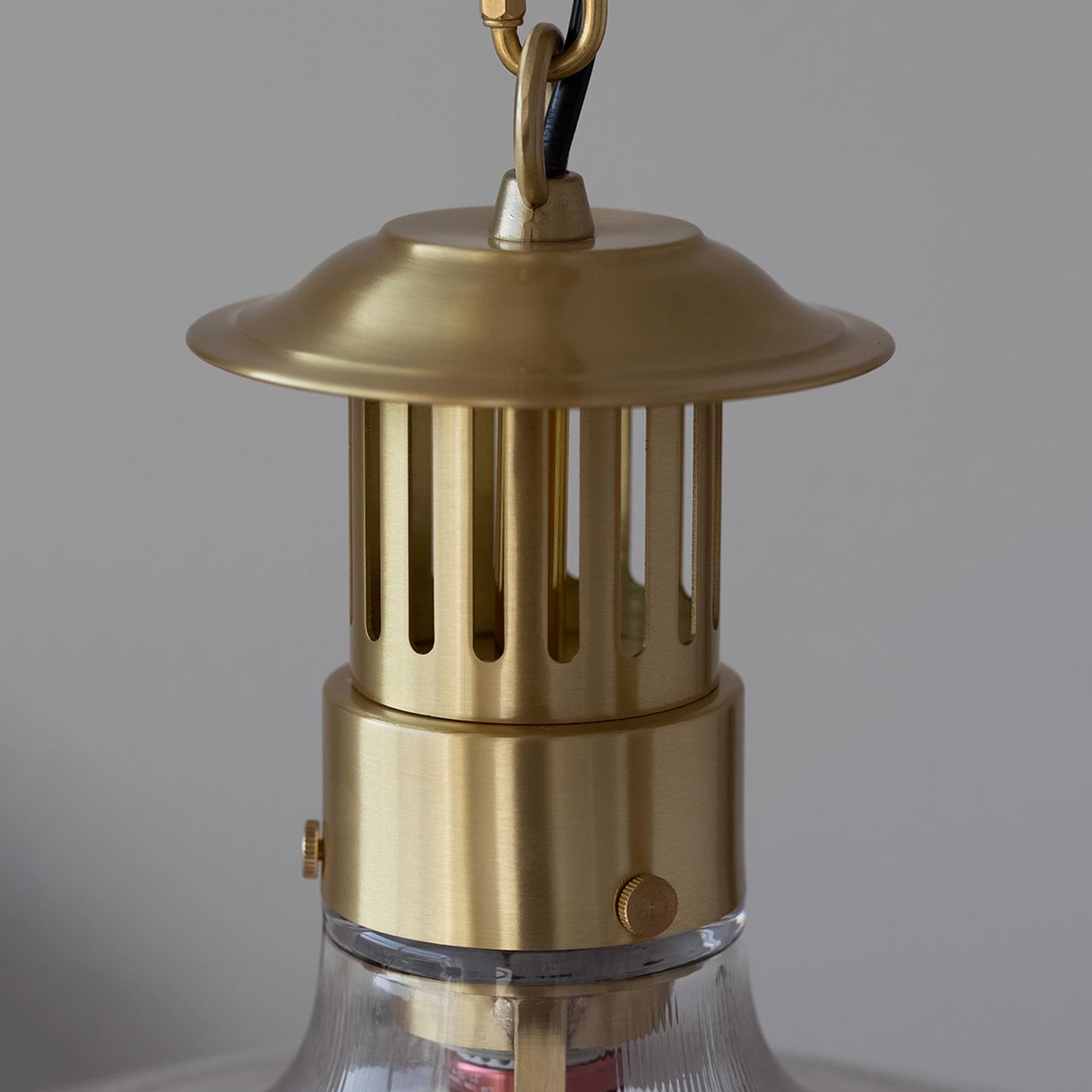Full product view of the Holophane pendant lamp with its hanging chain.