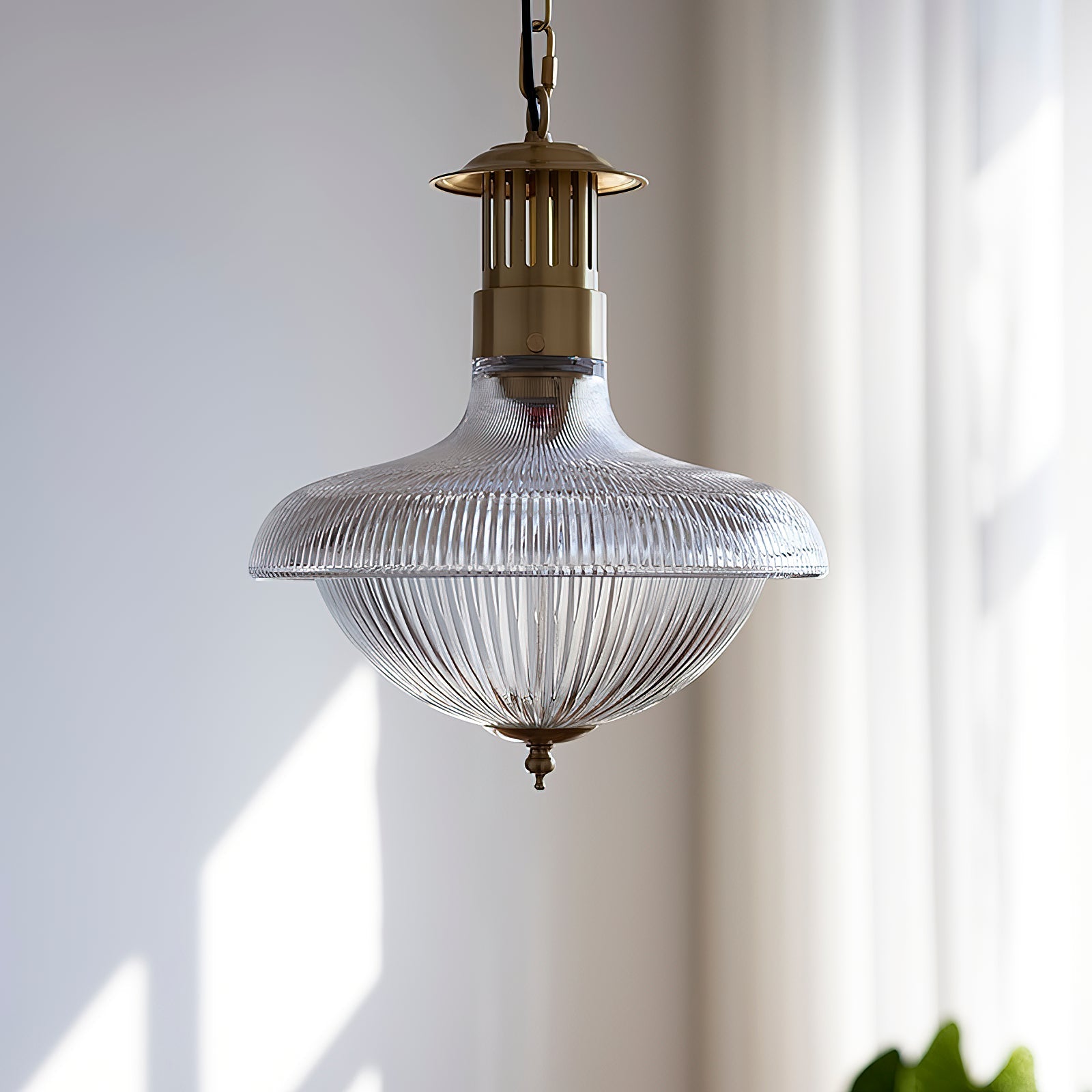 A pair of Holophane pendant lamps hanging over a kitchen island.