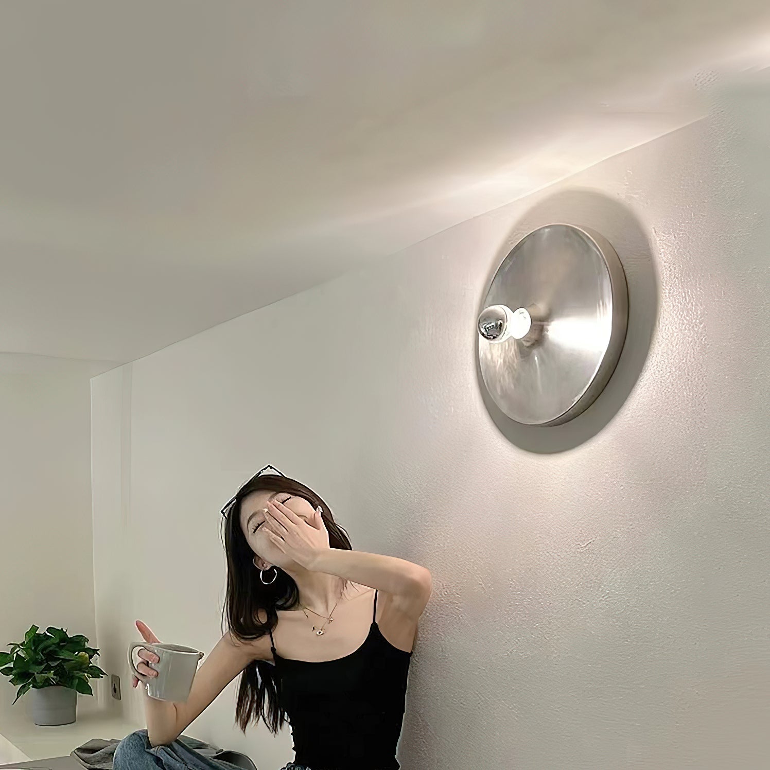 The wall lamp casting a warm, ambient glow in a hallway.