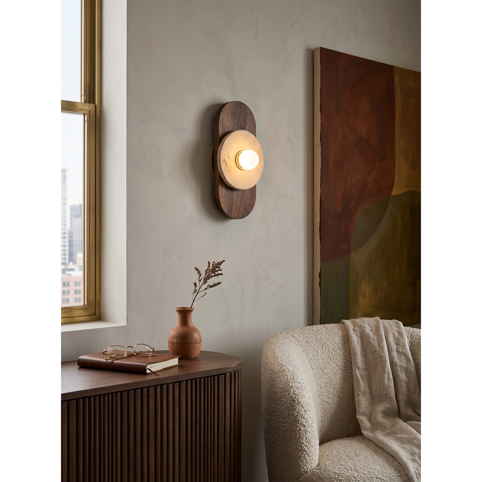 The wall sconce used as a refined bedside reading lamp.