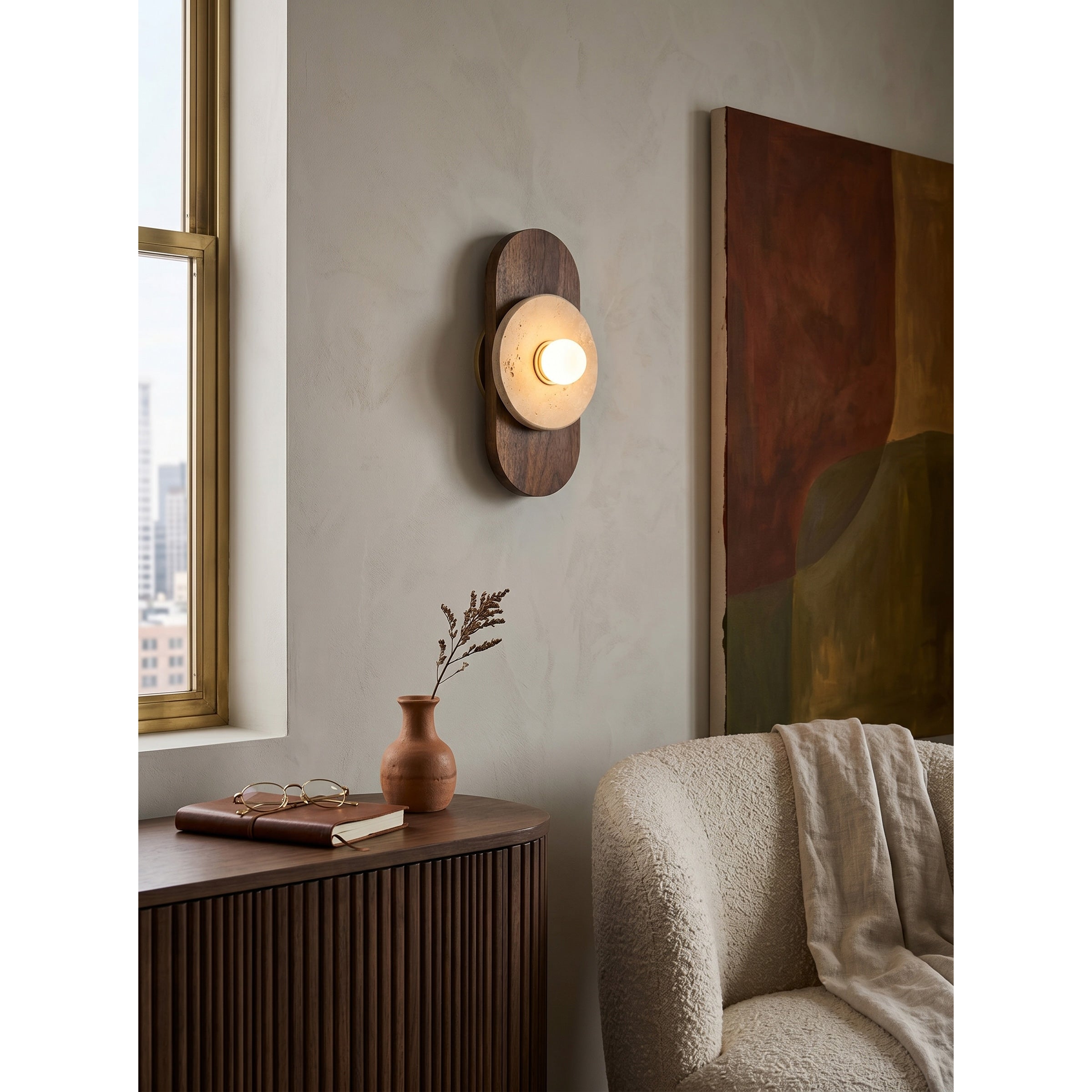 The wall sconce used as a refined bedside reading lamp.