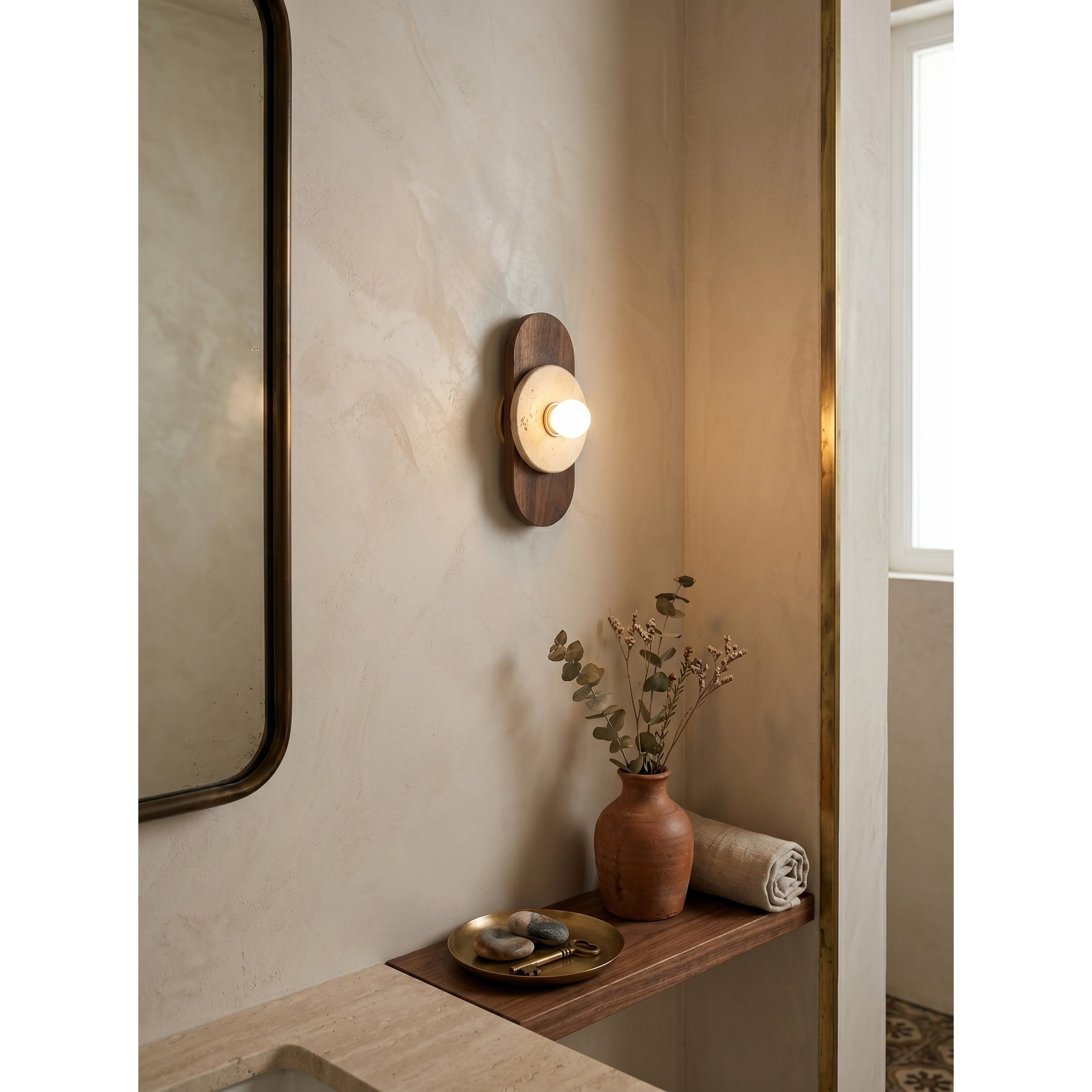 The wall sconce installed as a sculptural bathroom vanity light.