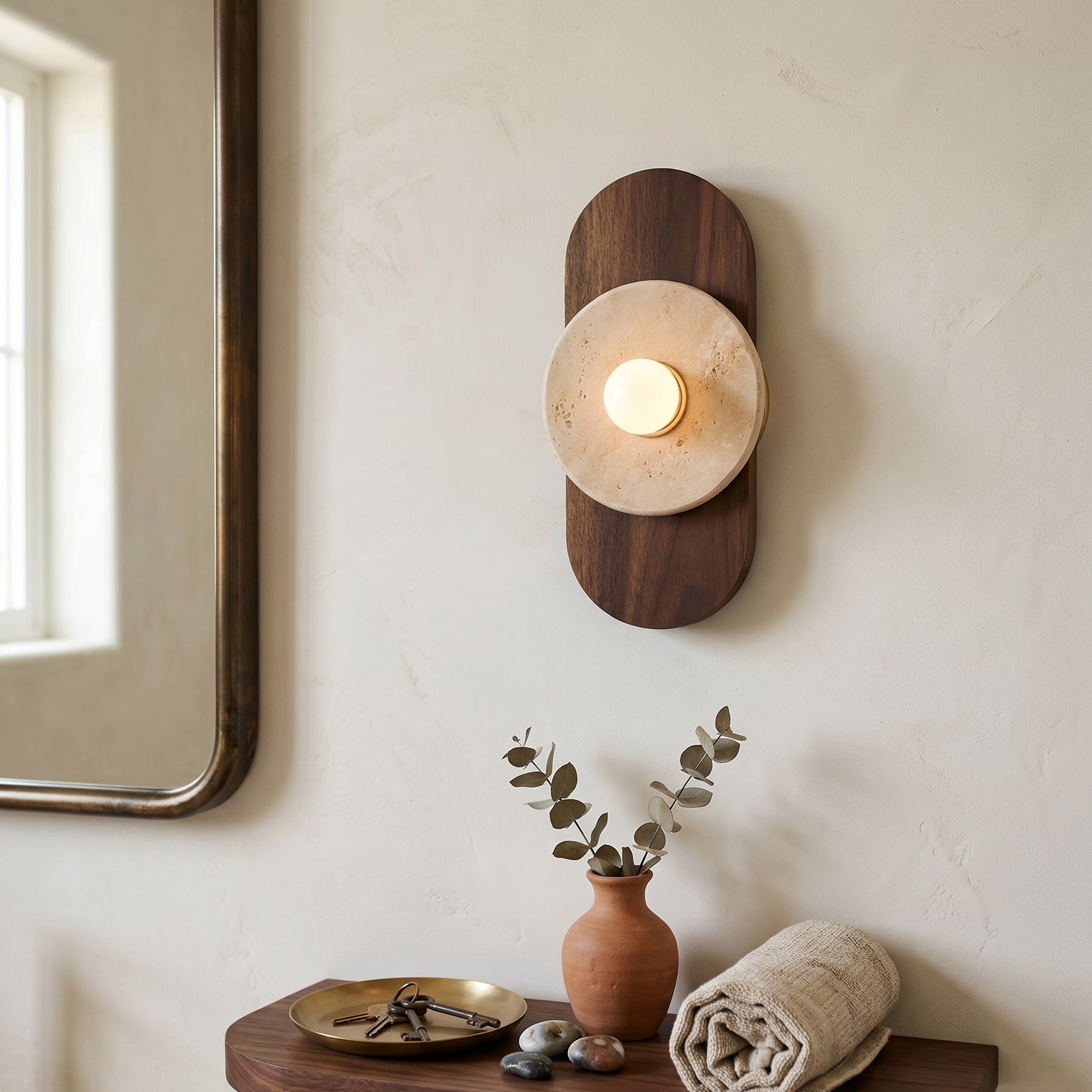 Angled view of the Horizon Travertine Wall Sconce showing its depth.