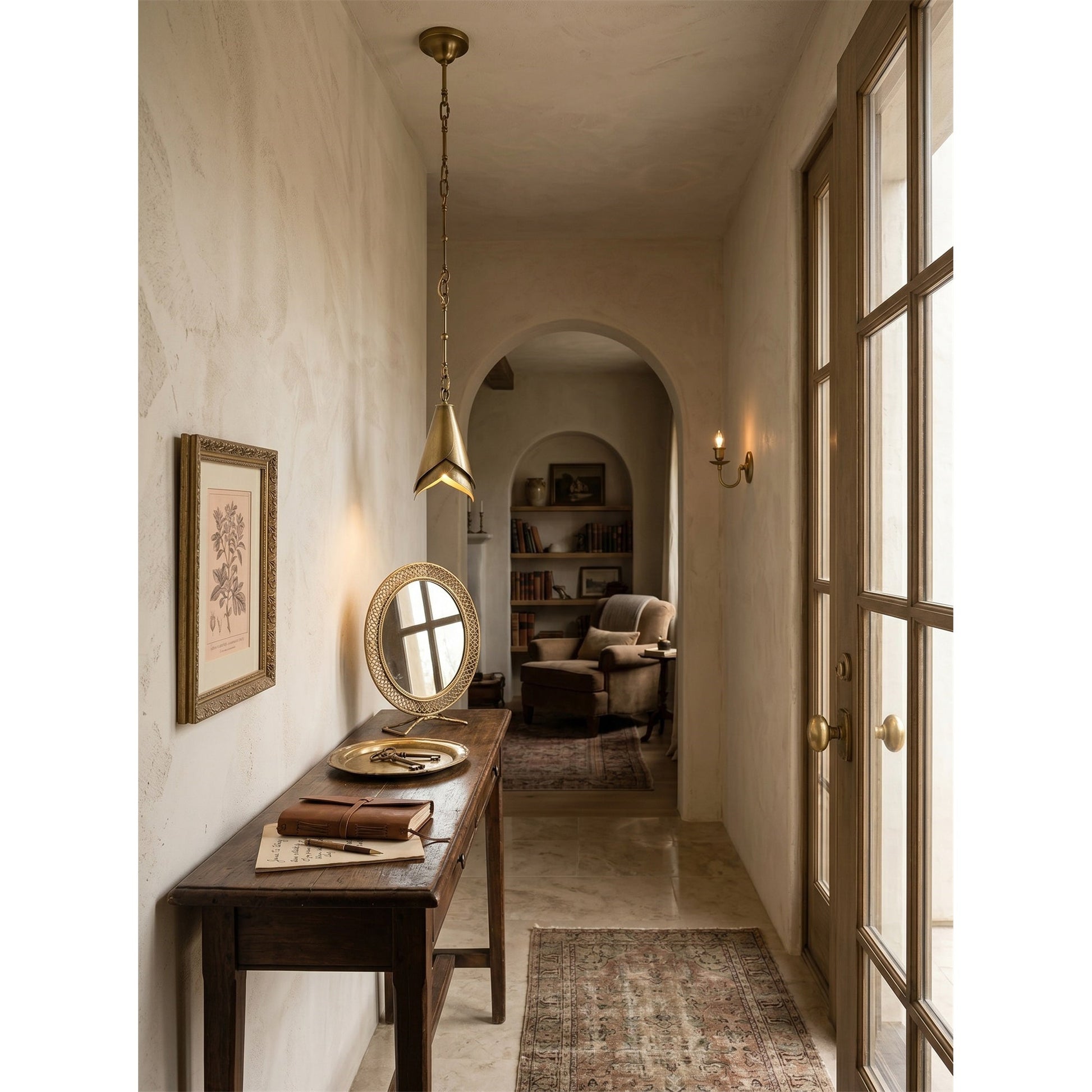 The lamp casting a warm, ambient glow in a high-ceiling entryway.