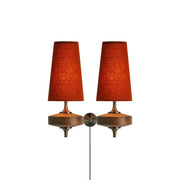 Front view of the Hour Rho single-head plug-in wall lamp with a natural white shade.