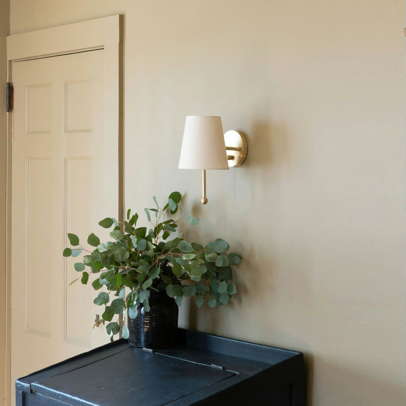 Side view of the brass wall sconce, showcasing its elegant structure.
