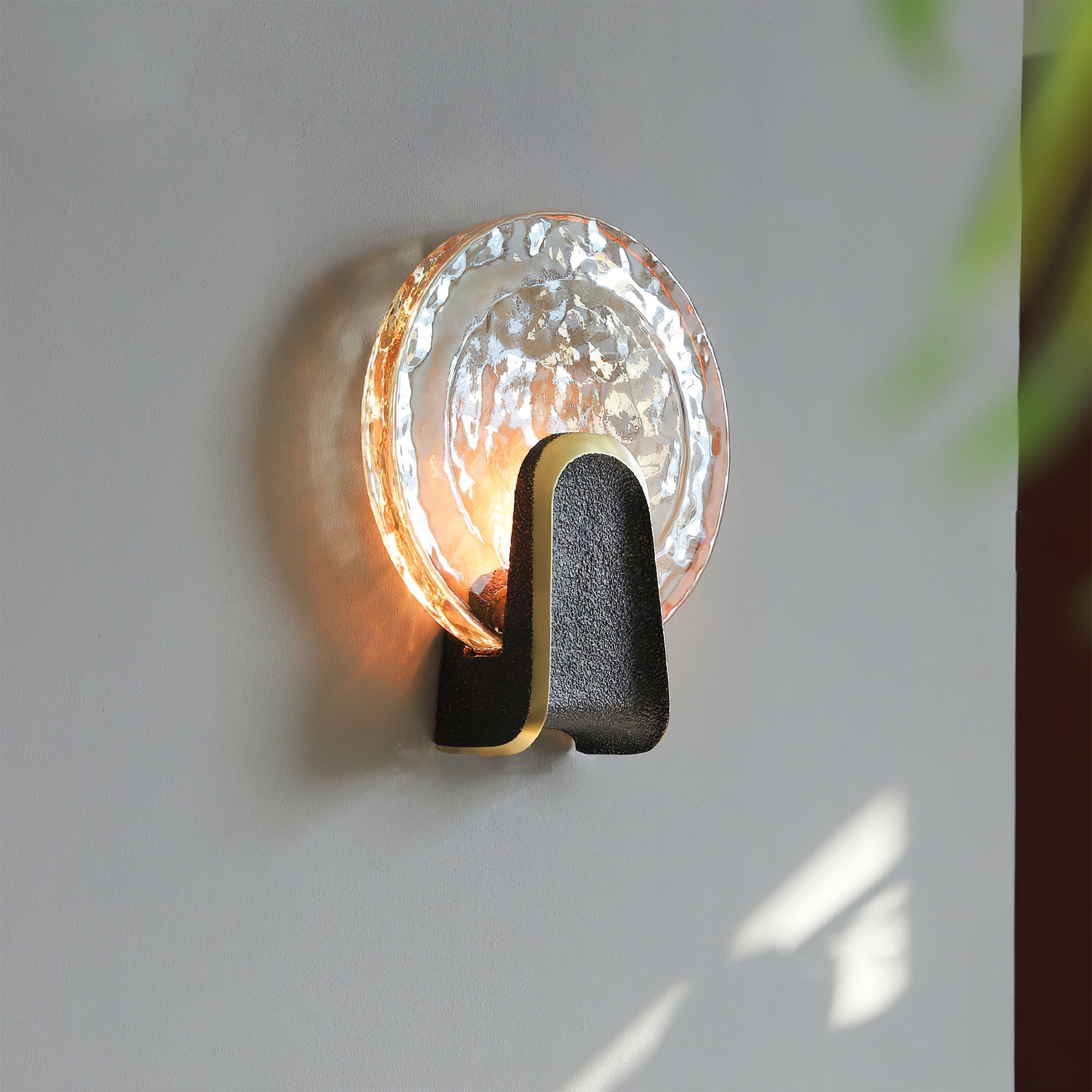 Close-up of the Ingot Wall Lamp's textured hand-cast glass.