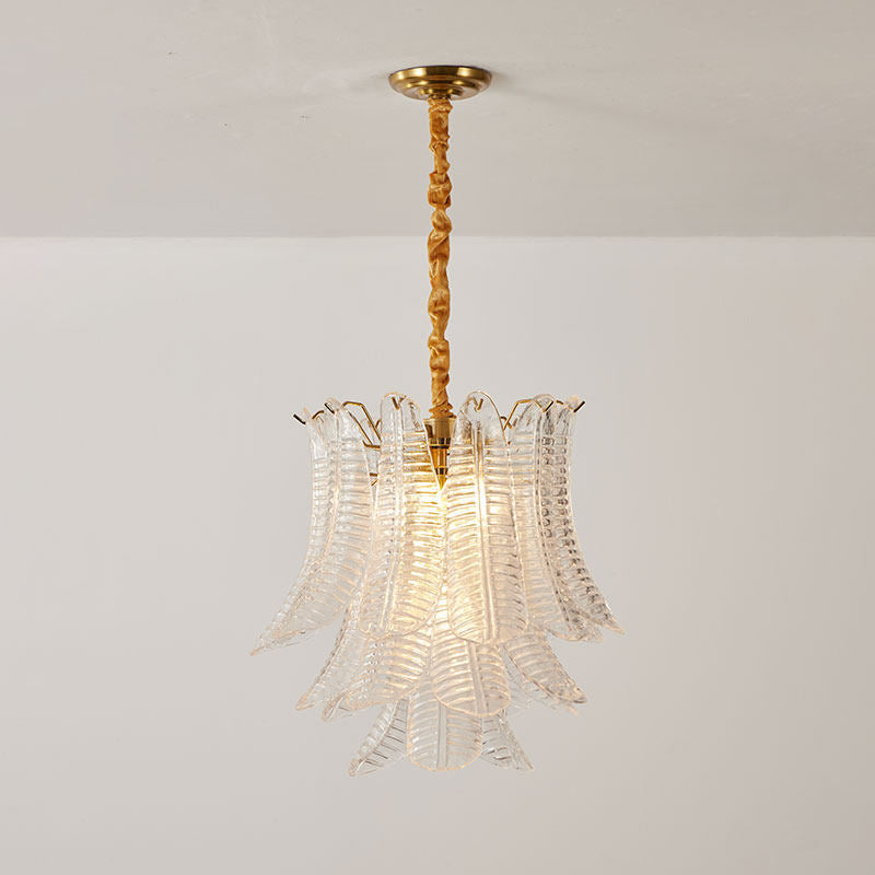 A view from below looking up at the layered glass leaves of the chandelier.