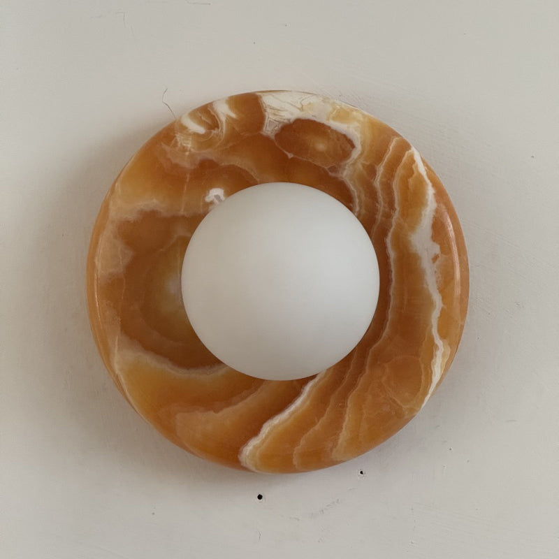 Orli Sconce unlit, highlighting the natural beauty of the stone.