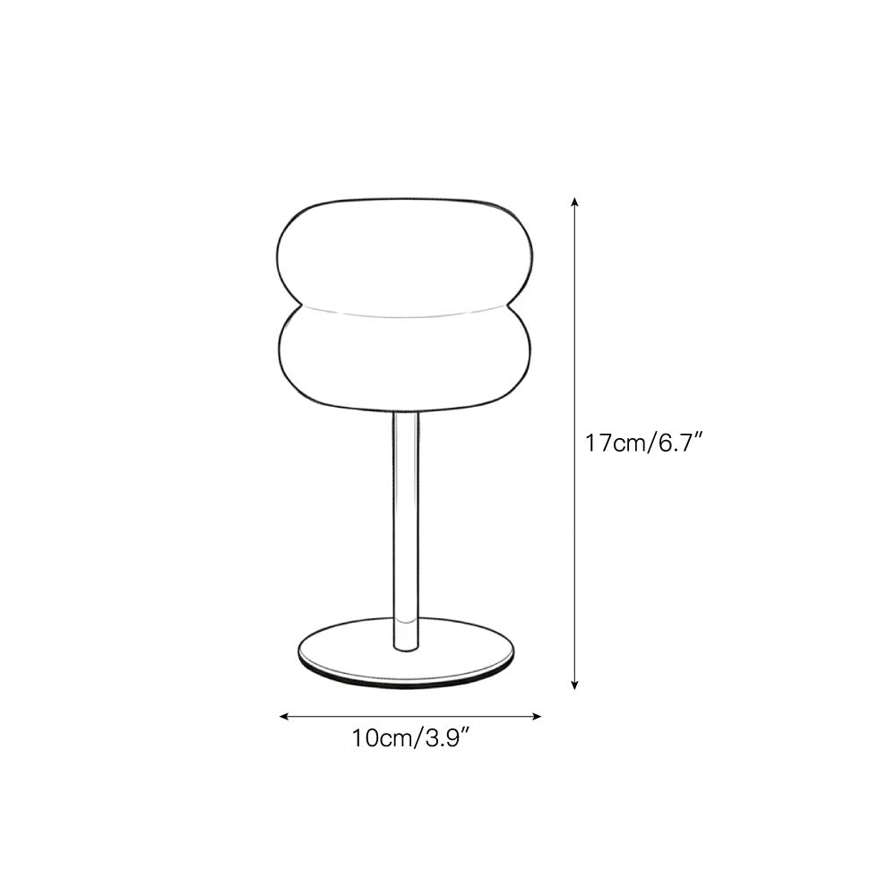 The table lamp shown from a side angle, highlighting its compact size.