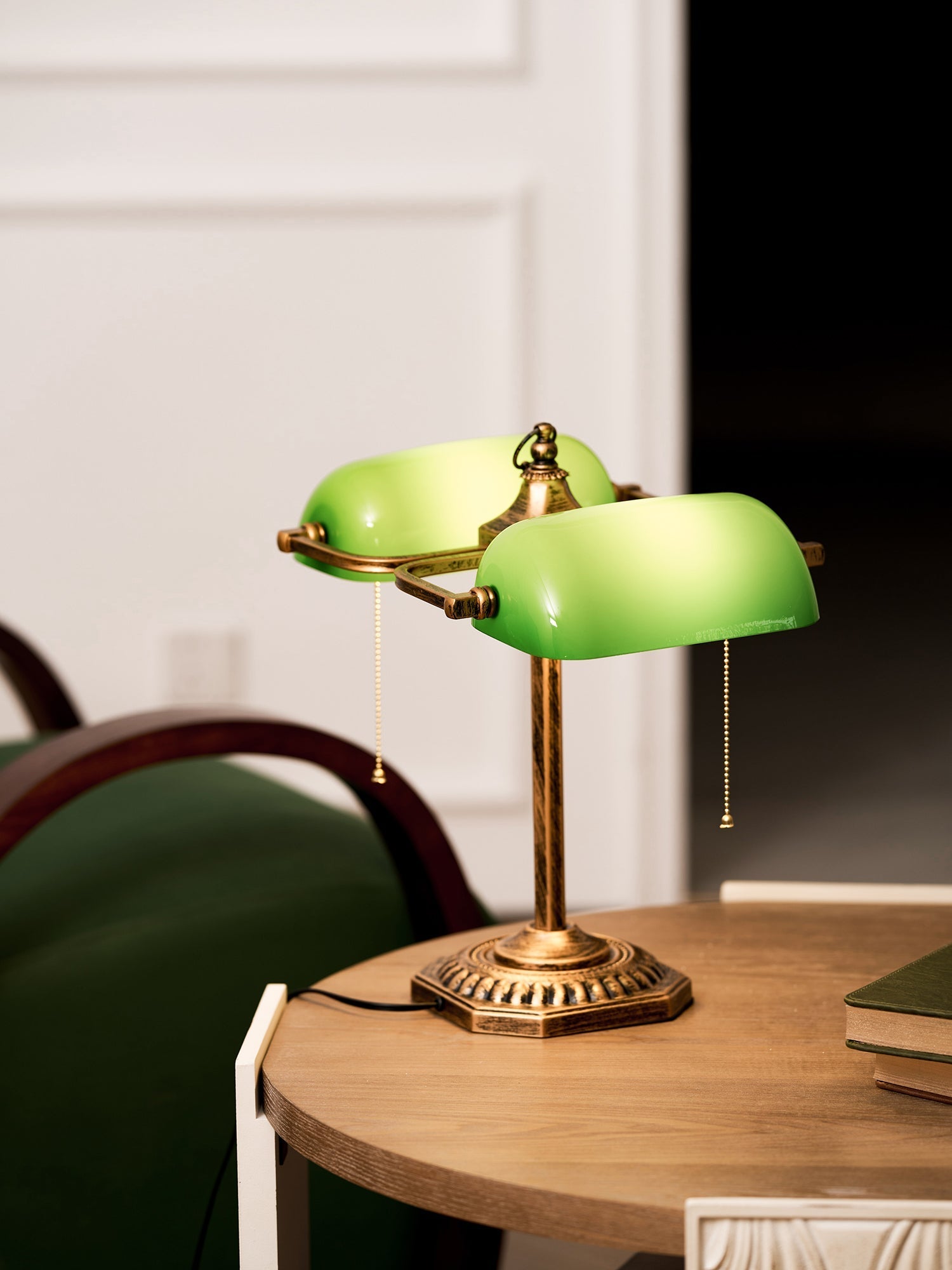 Close-up of the antique brass base of the library lamp.