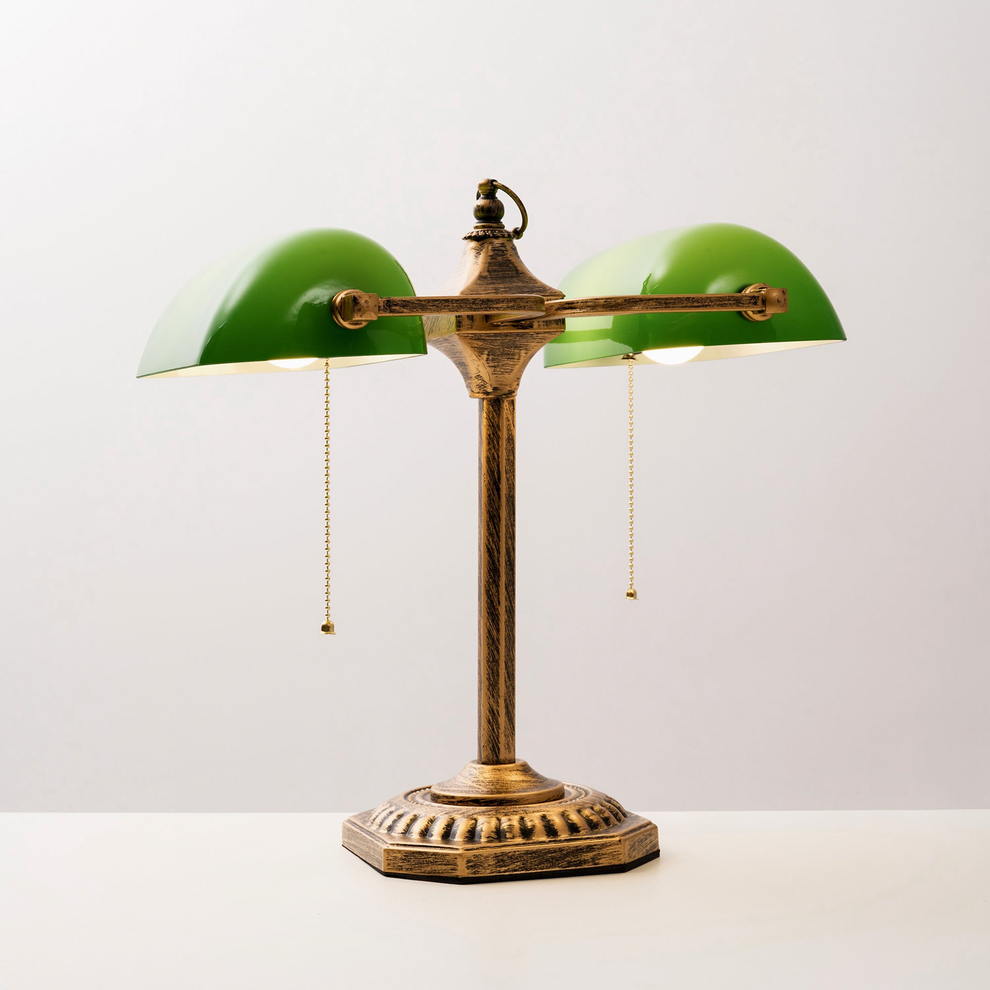Lifestyle image of the lamp on a side table next to a chair.