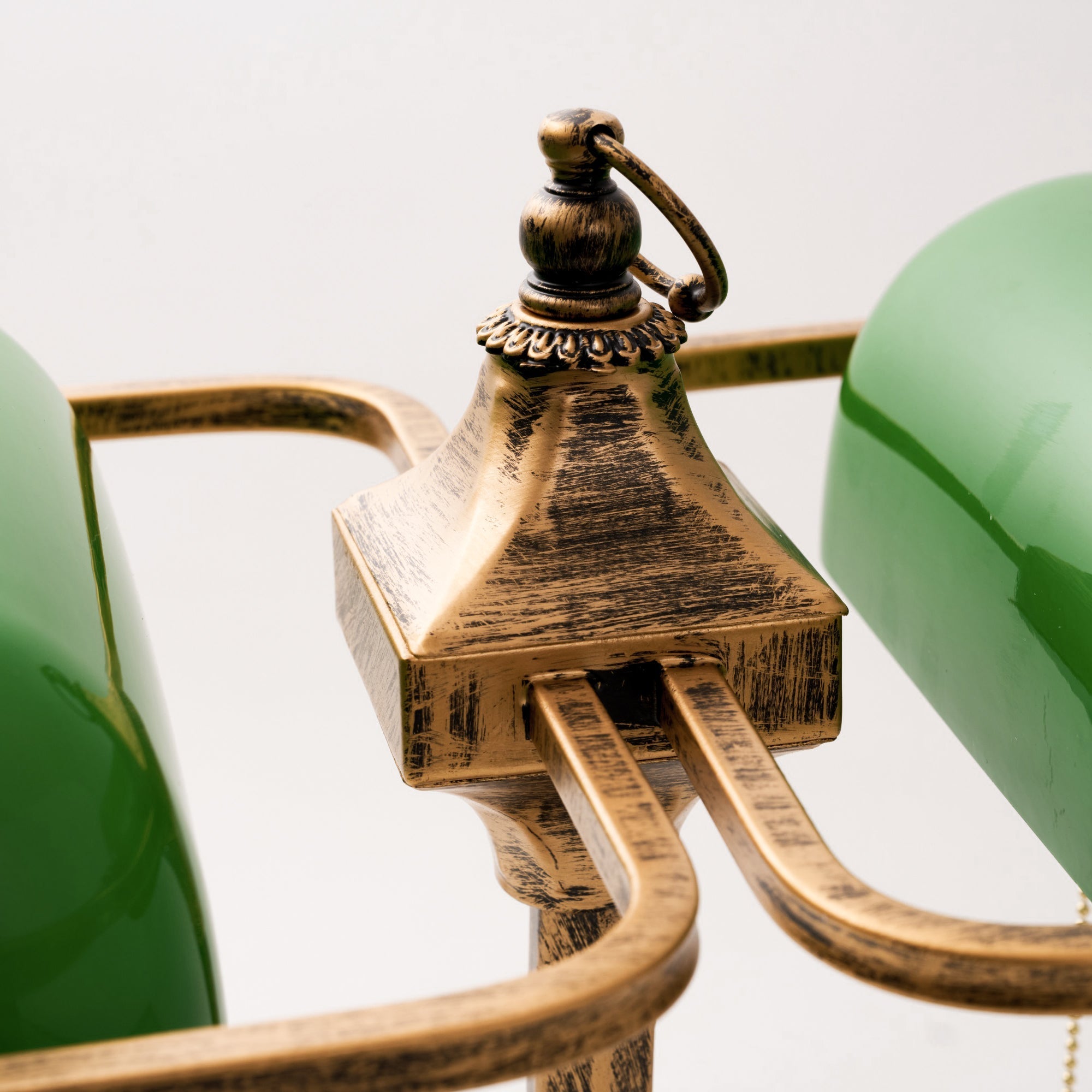 Close-up of the antique brass finish on the lamp's arm.