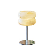 Alabaster Donut Table Lamp with a chrome base on a neutral background.